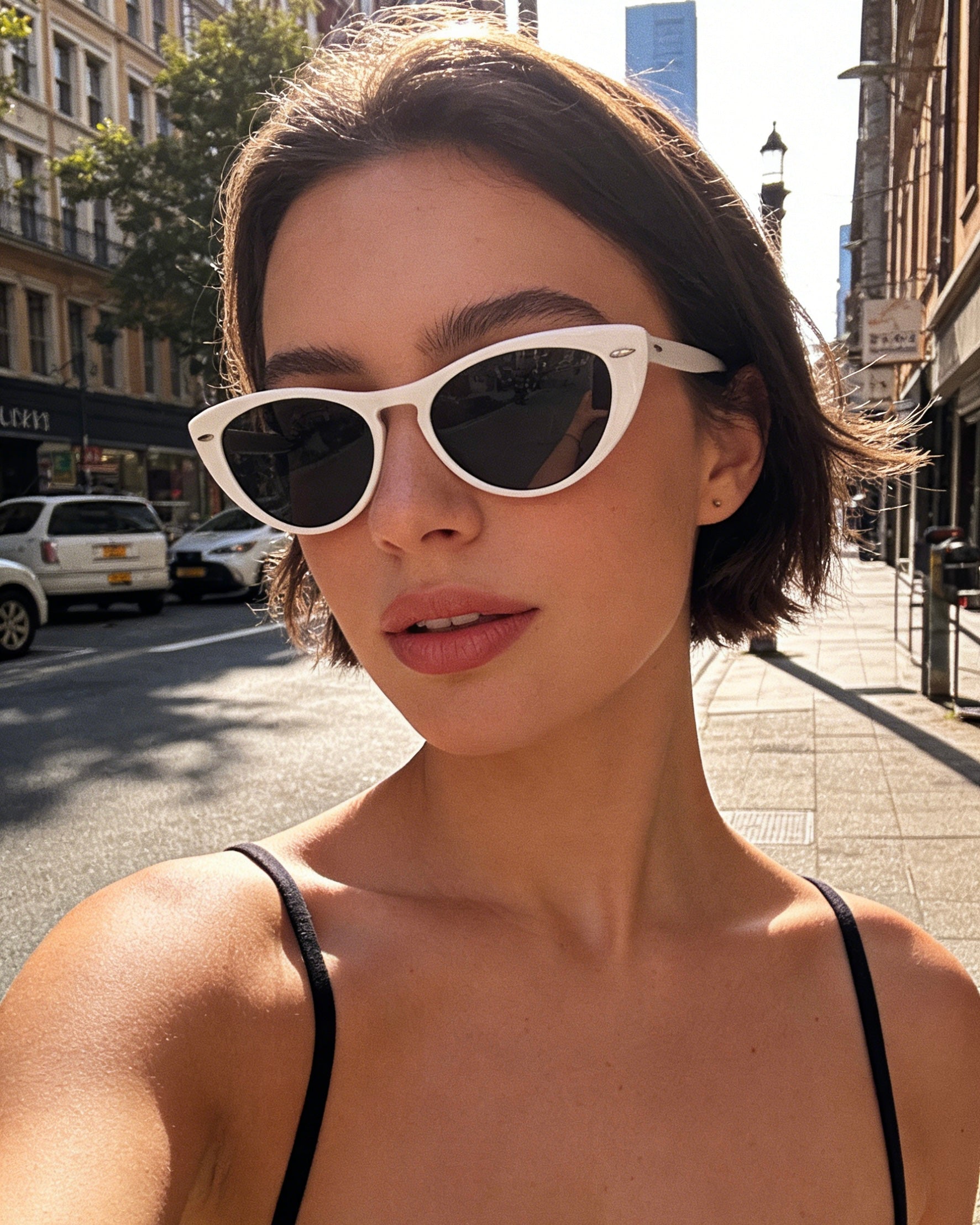 Modern white frame cat-eye sunglasses featuring grey polarized lenses and 100% UV protection, vintage aesthetic fashion sunglasses.