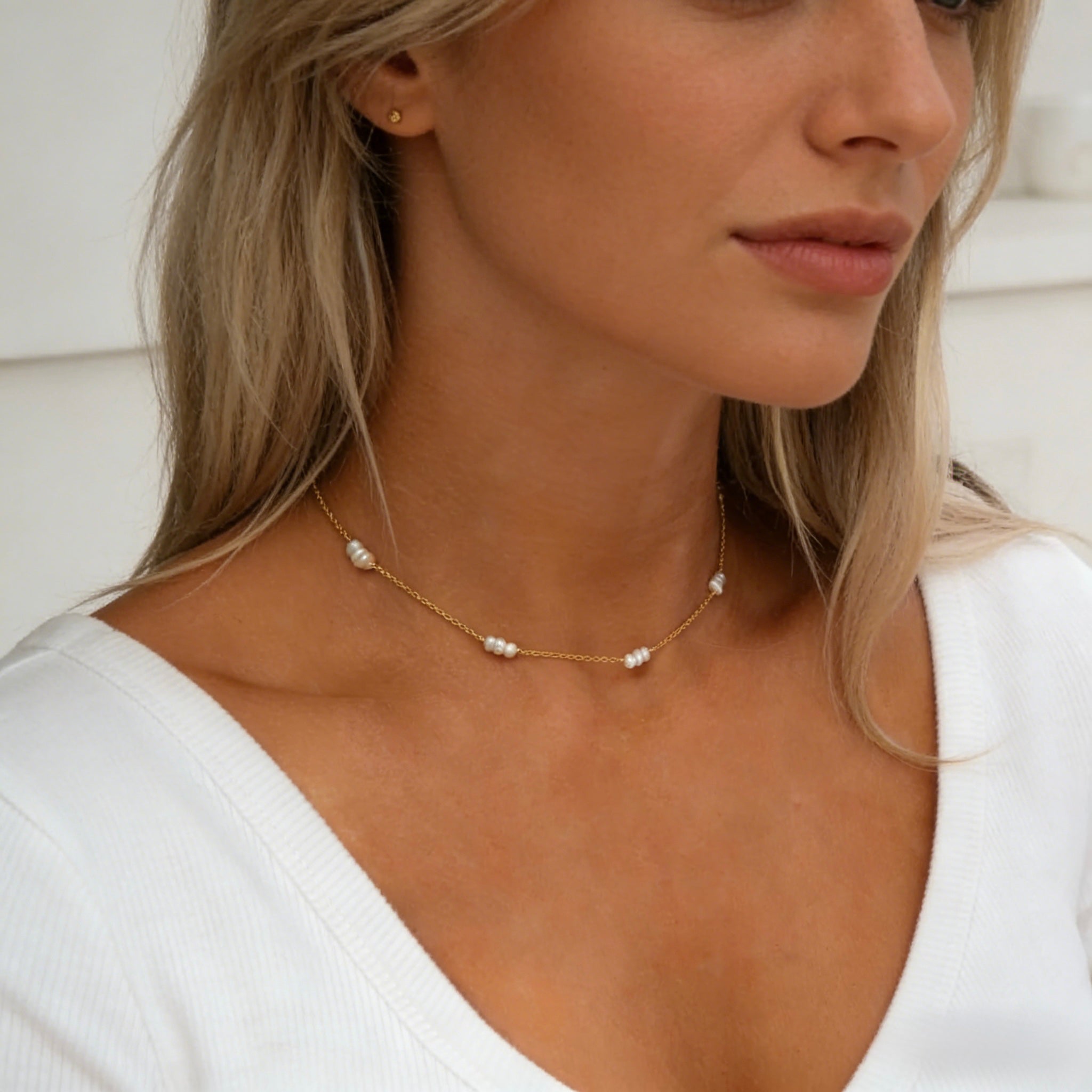 Dainty 18K gold plated station necklace featuring small white freshwater rice pearls spaced evenly on a fine gold chain