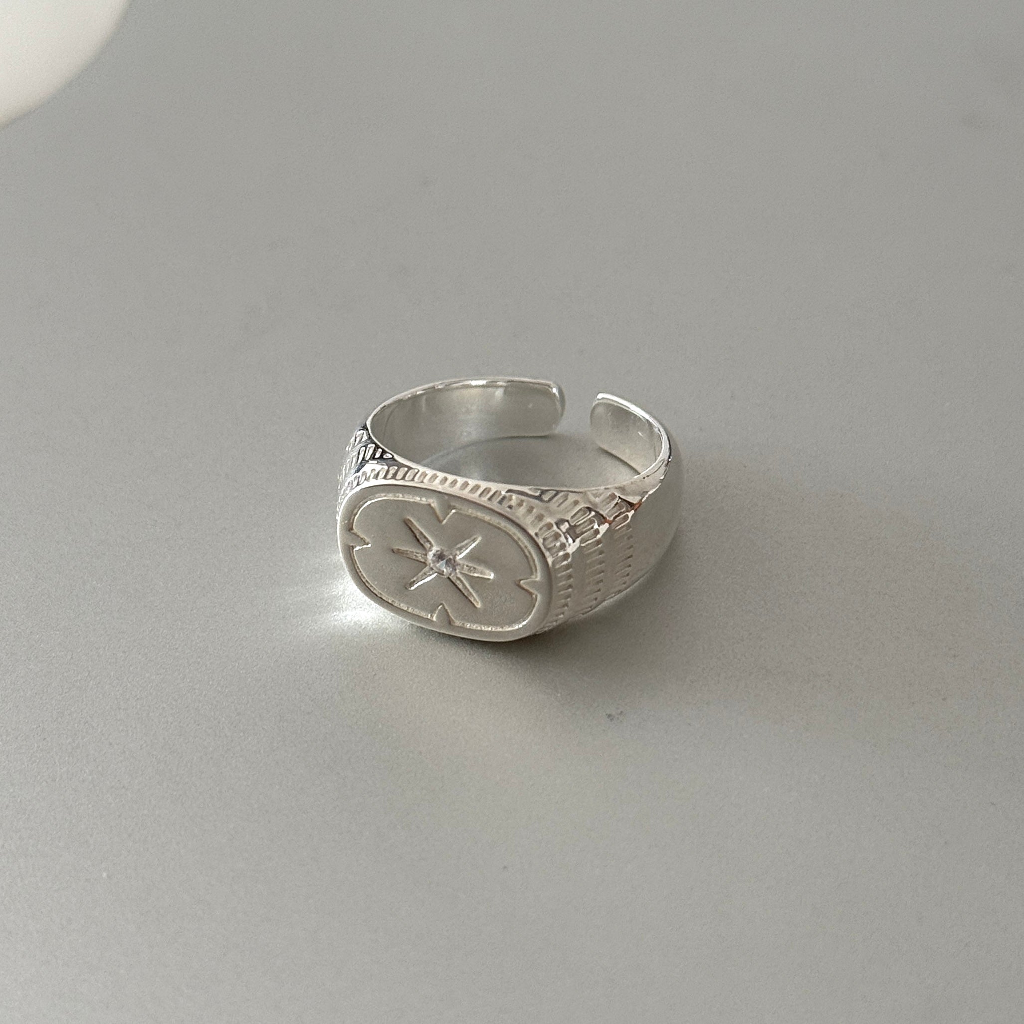 Sterling silver unisex ring with a chunky star design, a bold and architectural piece of statement jewelry.