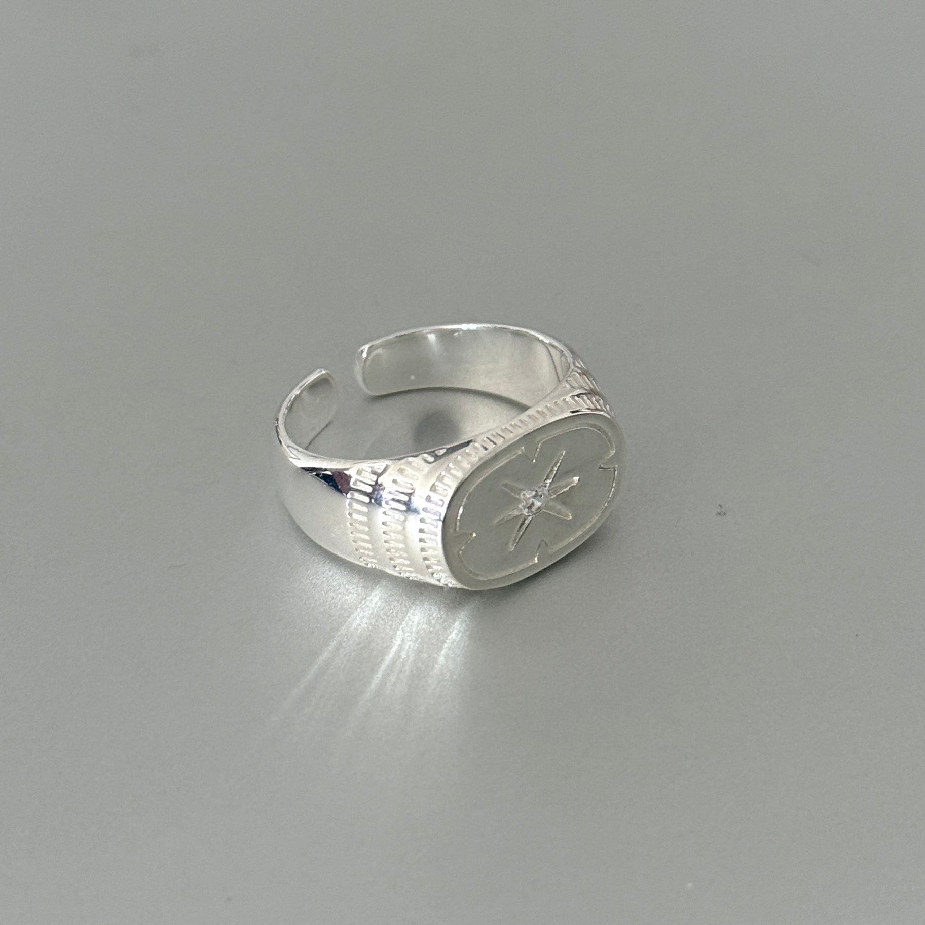 Sterling silver unisex ring with a chunky star design, a bold and architectural piece of statement jewelry.