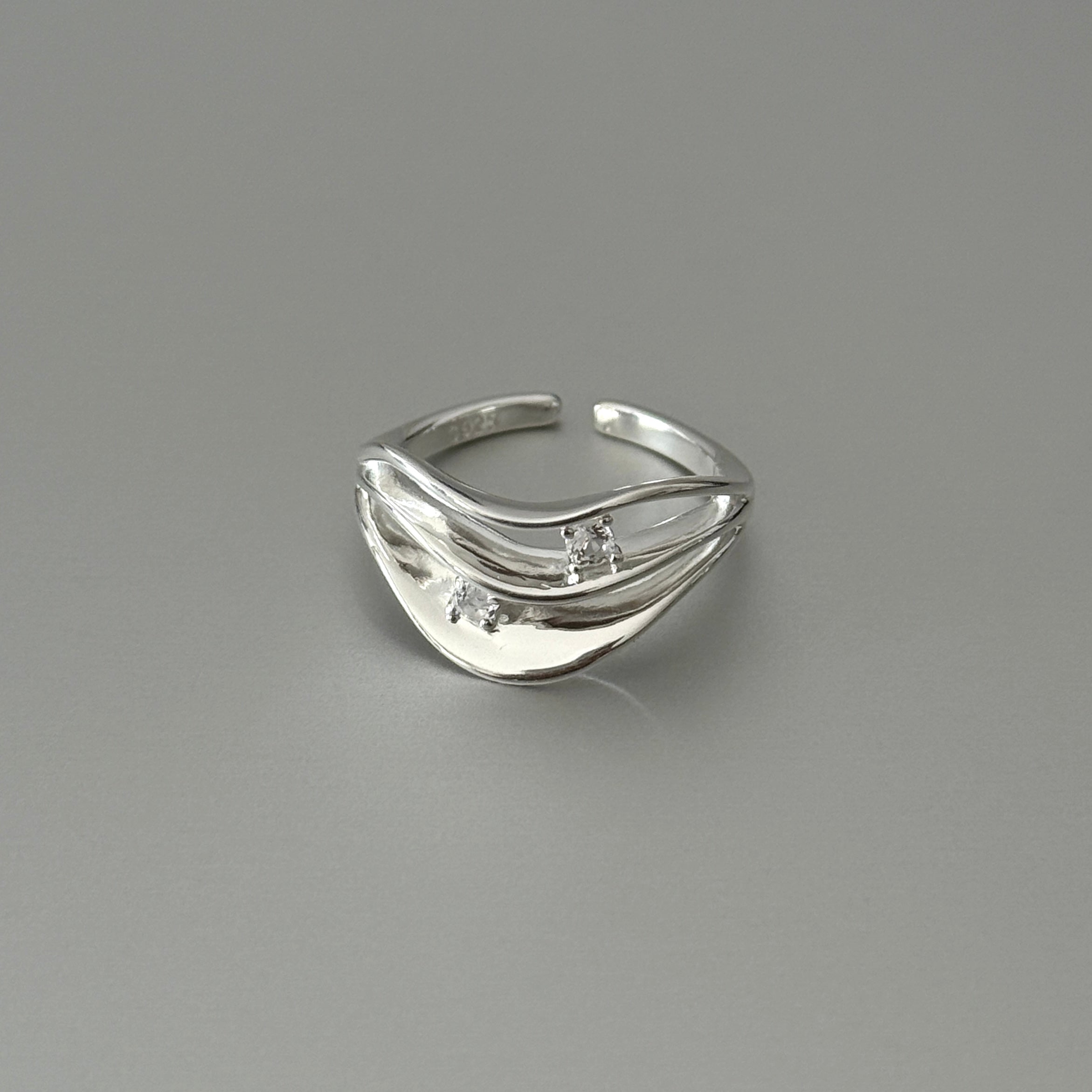 925 sterling silver with cubic zircon, sleek wave design for modern versatile jewelry