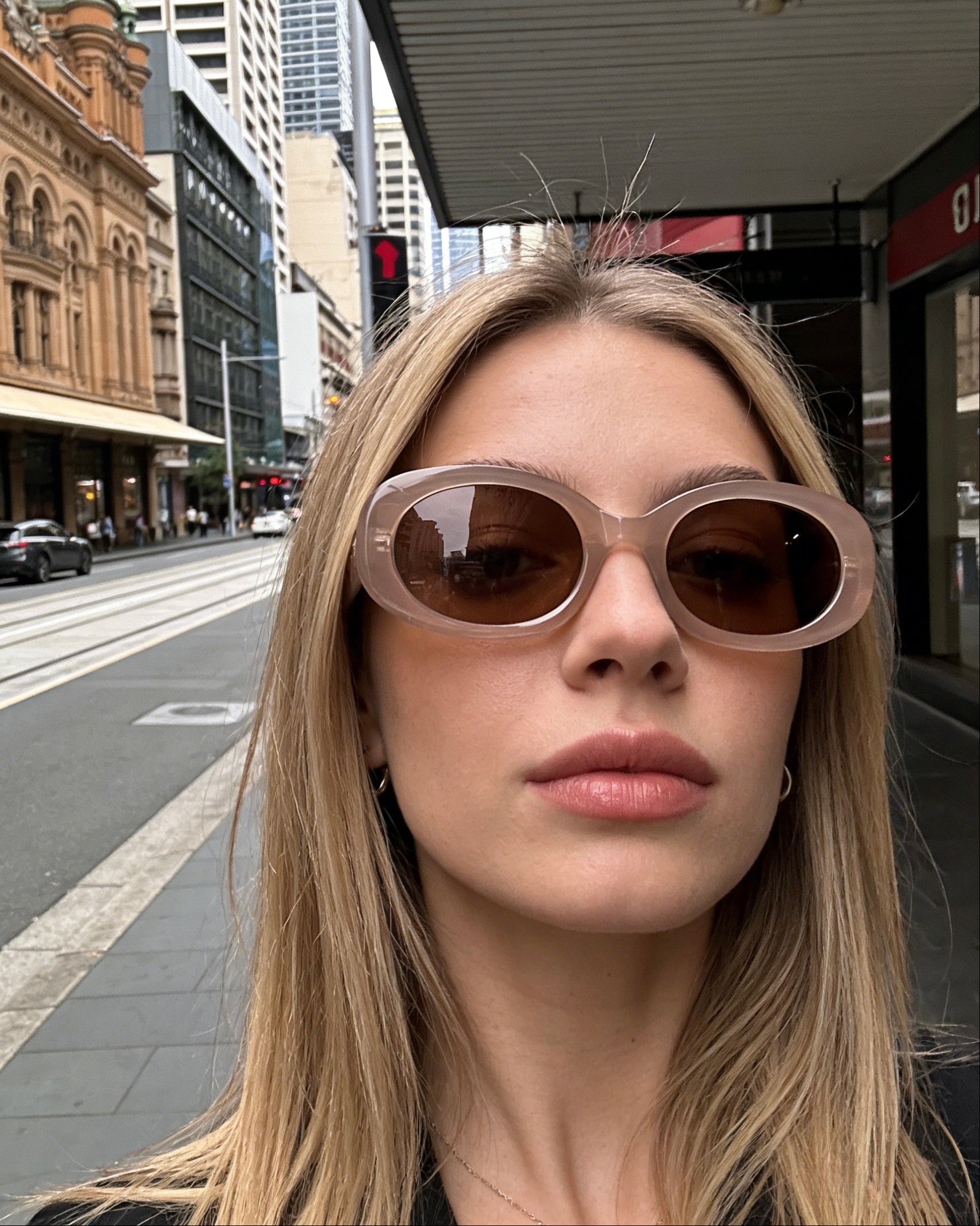 Nude blush oval sunglasses with thick frames and brown polarized lenses, UV protective minimalist eyewear in "Clean Girl" aesthetic. Translucent dusty pink cat-eye sunglasses with gradient polarized lenses and UV protection, retro chic eyewear for women.