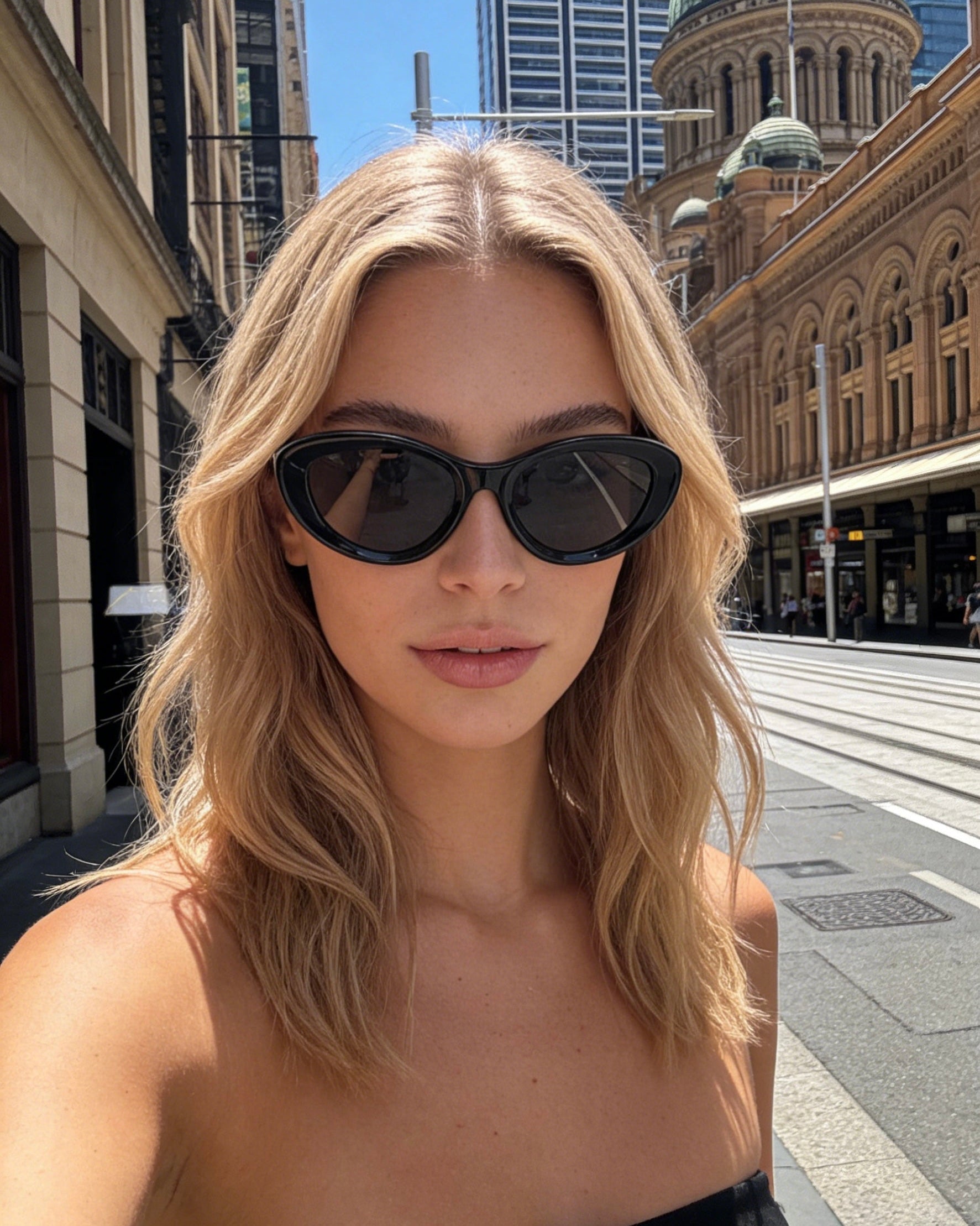 Classic black bold frame cat-eye sunglasses with polarized lenses and UV protection, aesthetic minimalist eyewear.