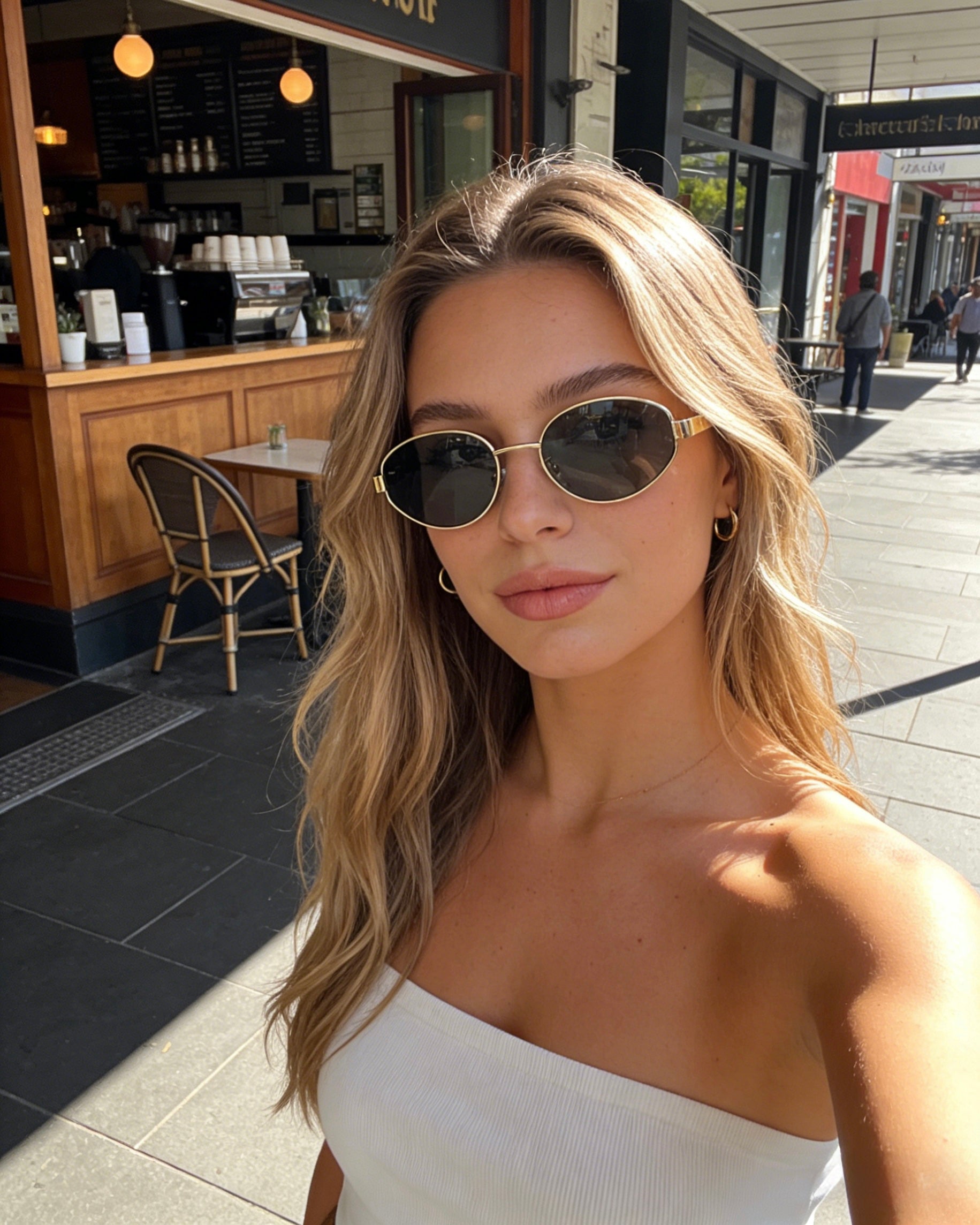 Classic oval polarized sunglasses with gold metal frame and black lenses, featuring 100% UV protection. Polarized black lens sunglasses with UV protection and stylish gold oval frames for sun safety.