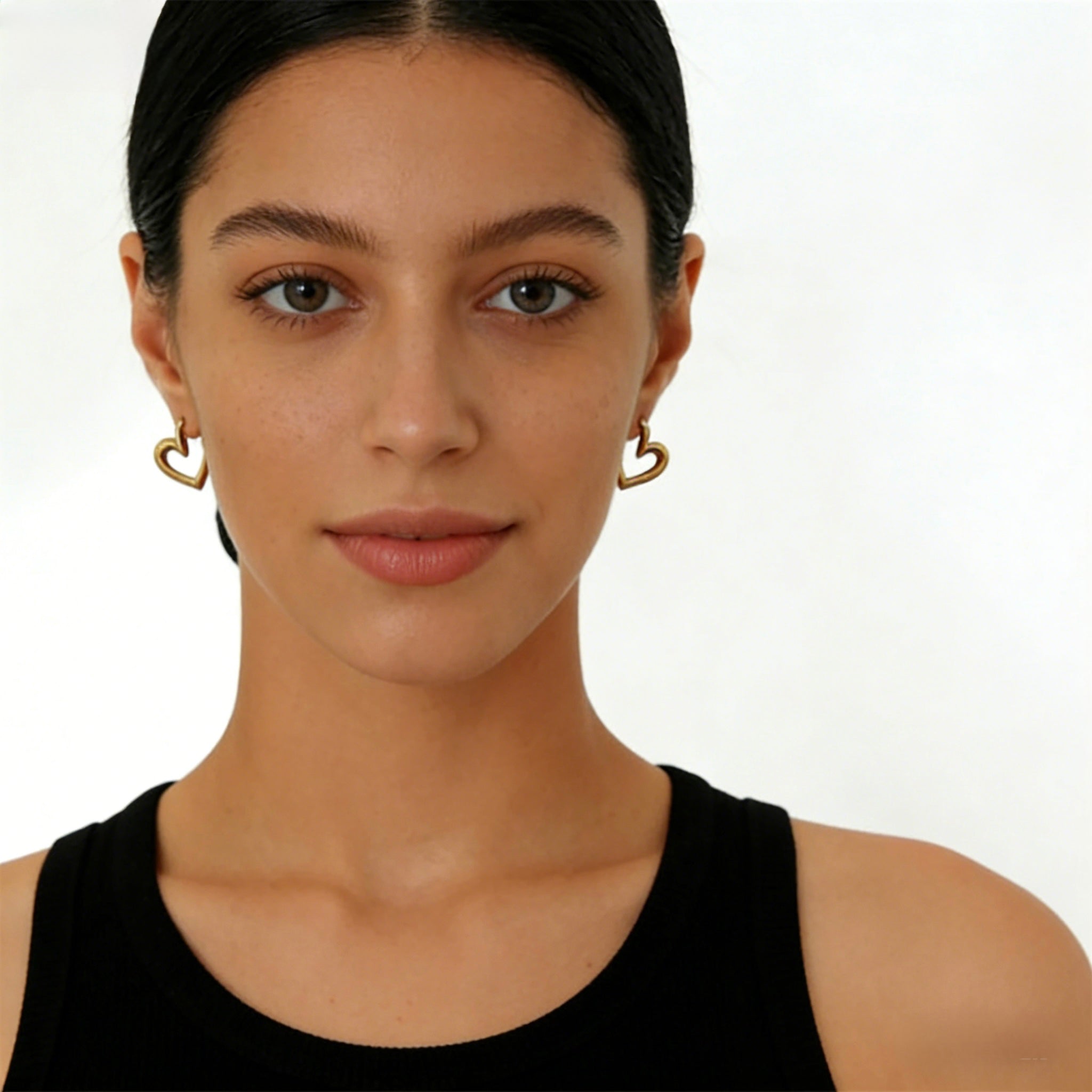 Pair of minimalist 18K gold plated heart hoop earrings featuring unique V-shape architectural lines and S925 sterling silver posts for sensitive ears