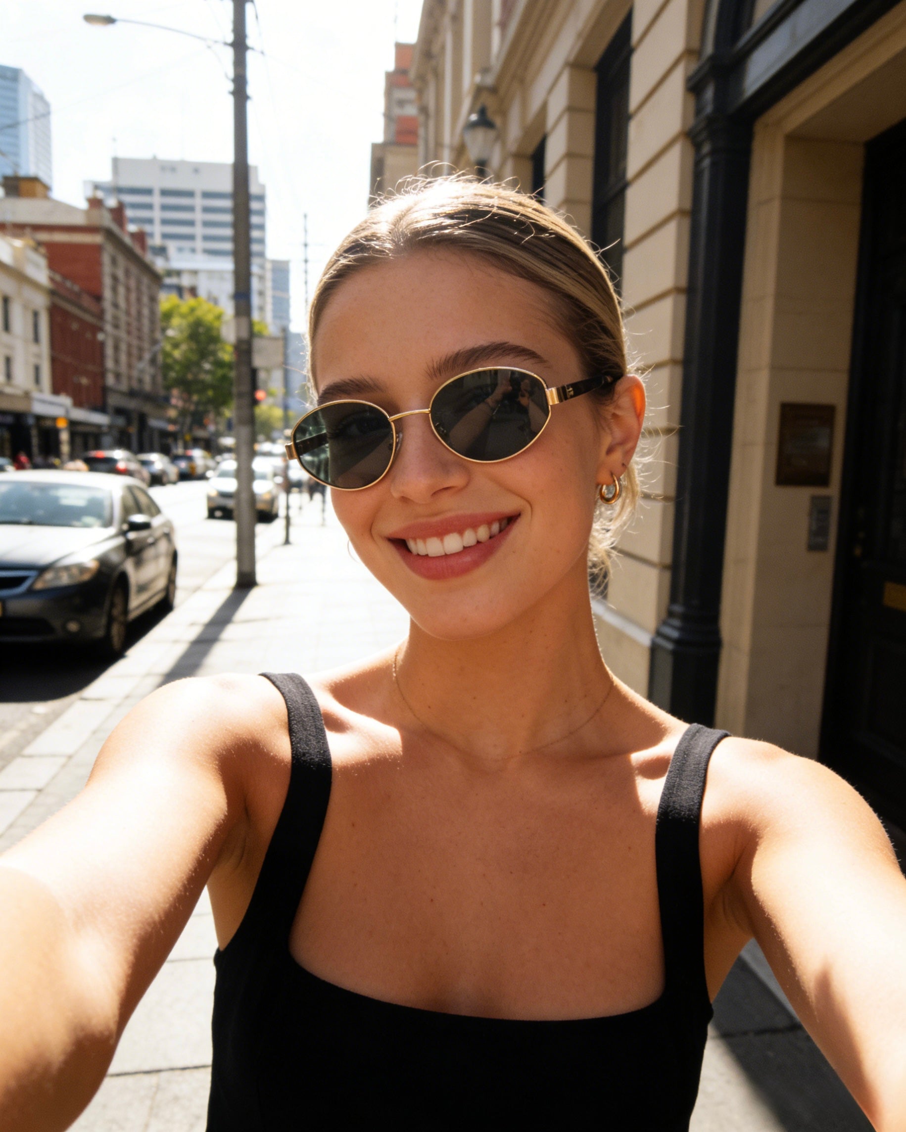 Classic oval polarized sunglasses with gold metal frame and black lenses, featuring 100% UV protection. Polarized black lens sunglasses with UV protection and stylish gold oval frames for sun safety.