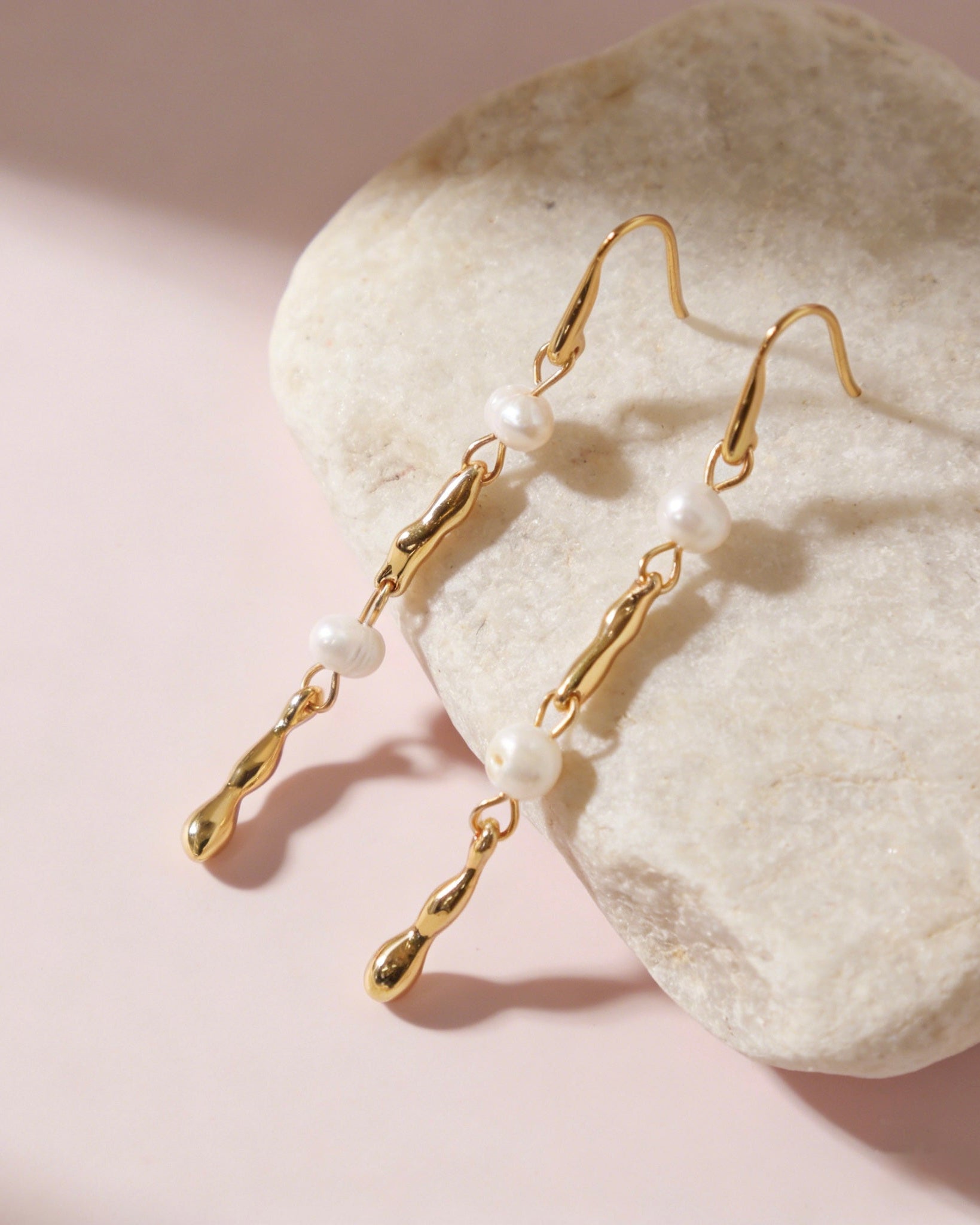 Elegant long 18K gold plated drop earrings featuring fluid melted metal bars and two lustrous white freshwater pearls with S925 sterling silver post.