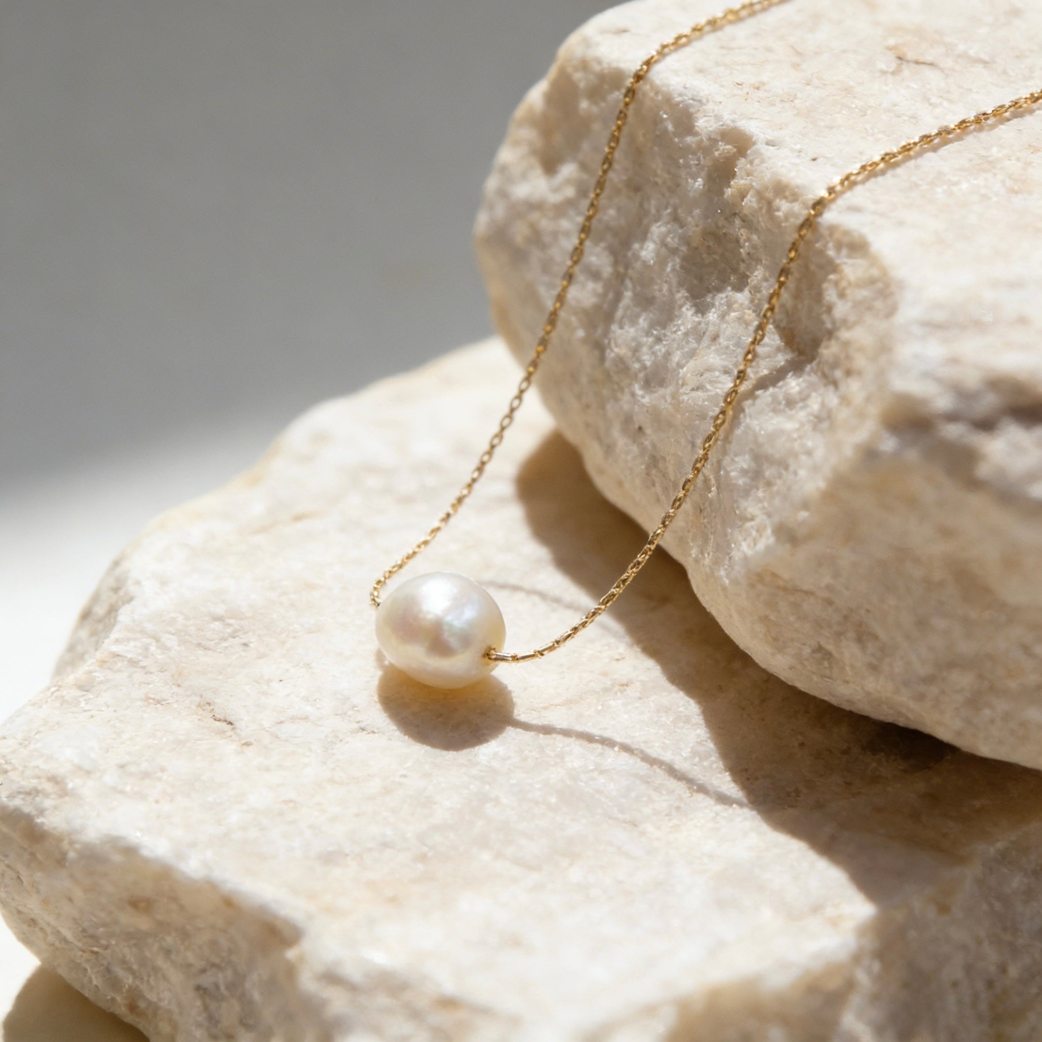 Minimalist 18K gold plated floating necklace with a natural white freshwater baroque pearl on a dainty cable chain