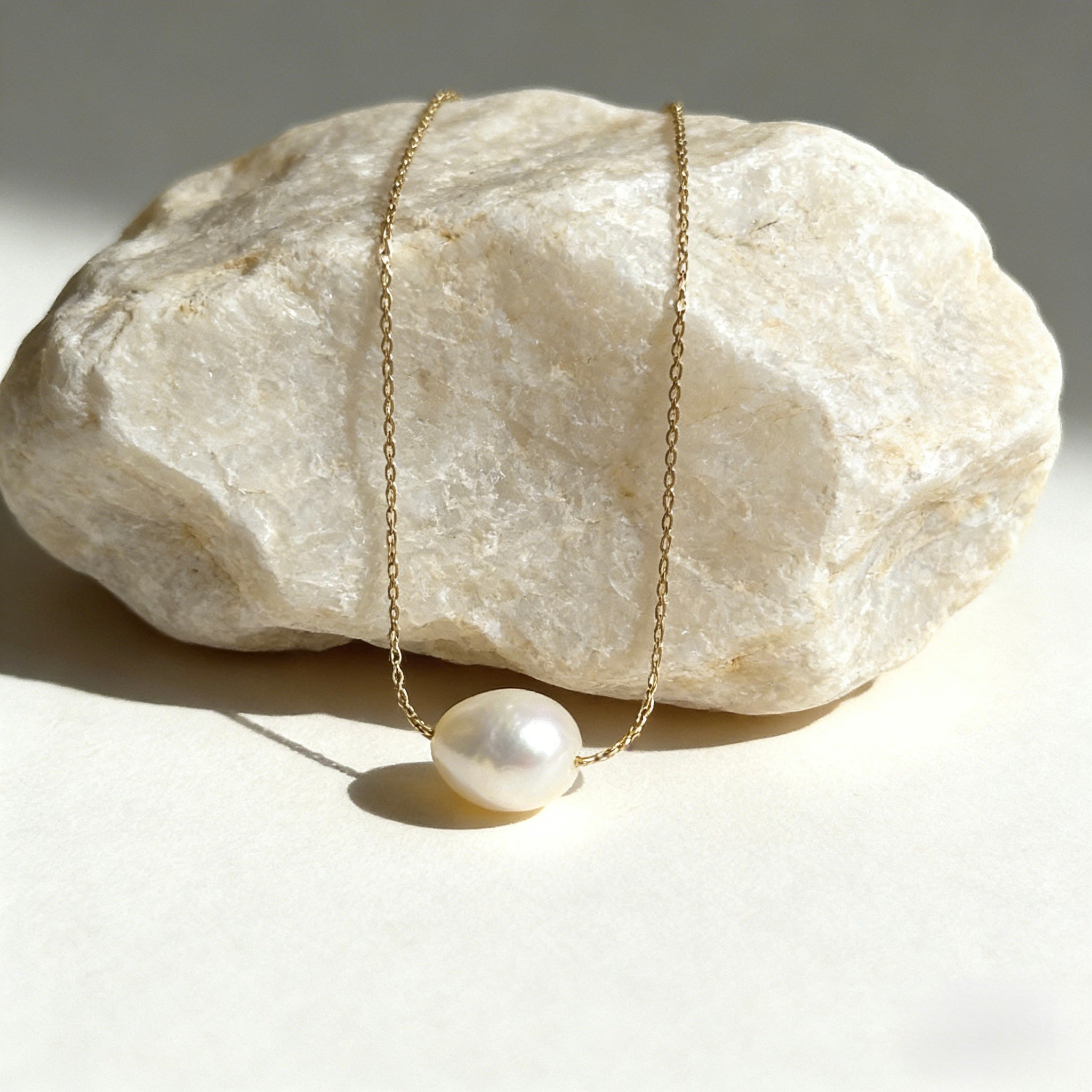 Minimalist 18K gold plated floating necklace with a natural white freshwater baroque pearl on a dainty cable chain