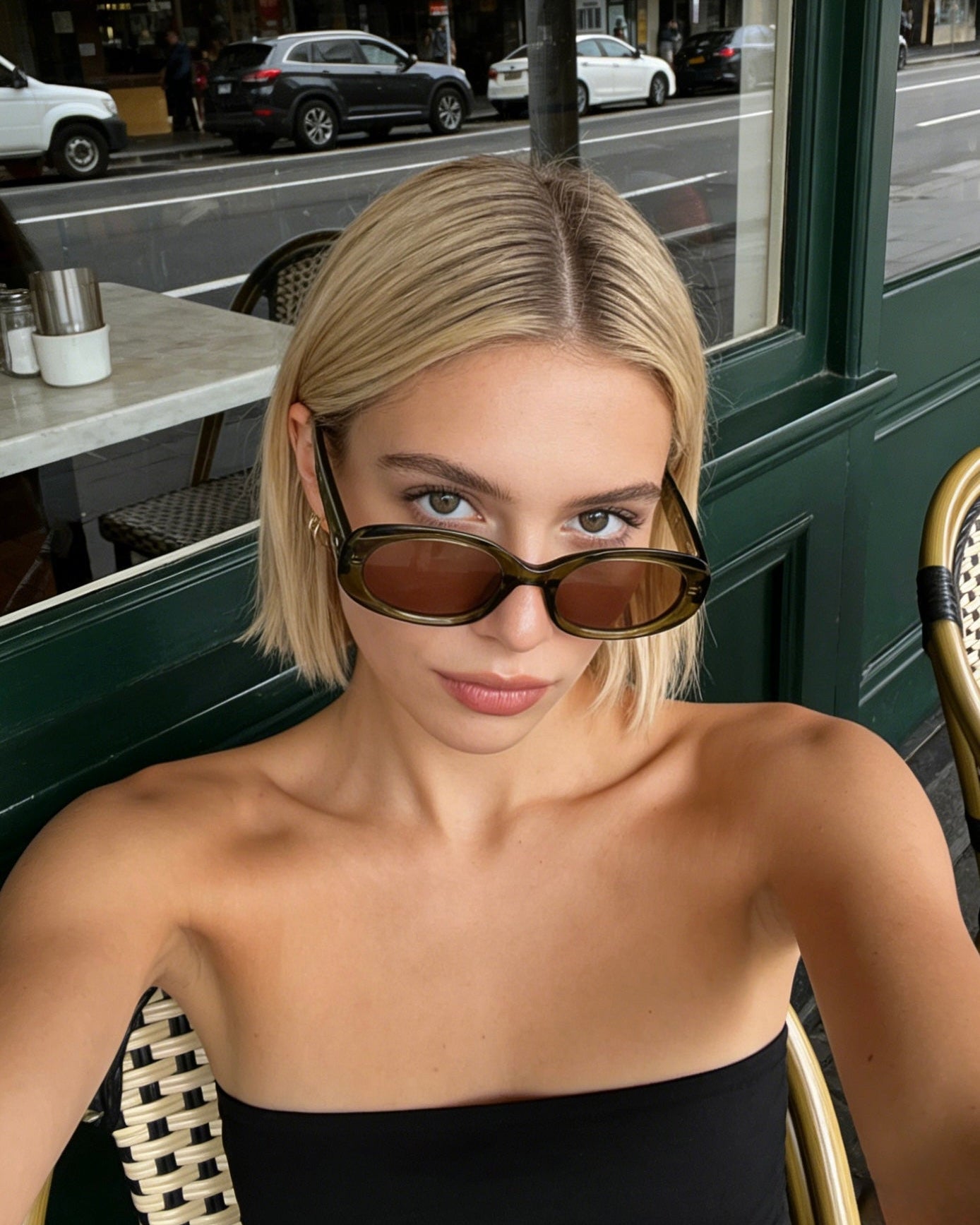 Polarized olive green oval sunglasses, UV400 protective lenses, stylish retro shades with a translucent frame.Translucent olive green oval sunglasses with polarized tea lenses and UV protection, vintage aesthetic eyewear for women.