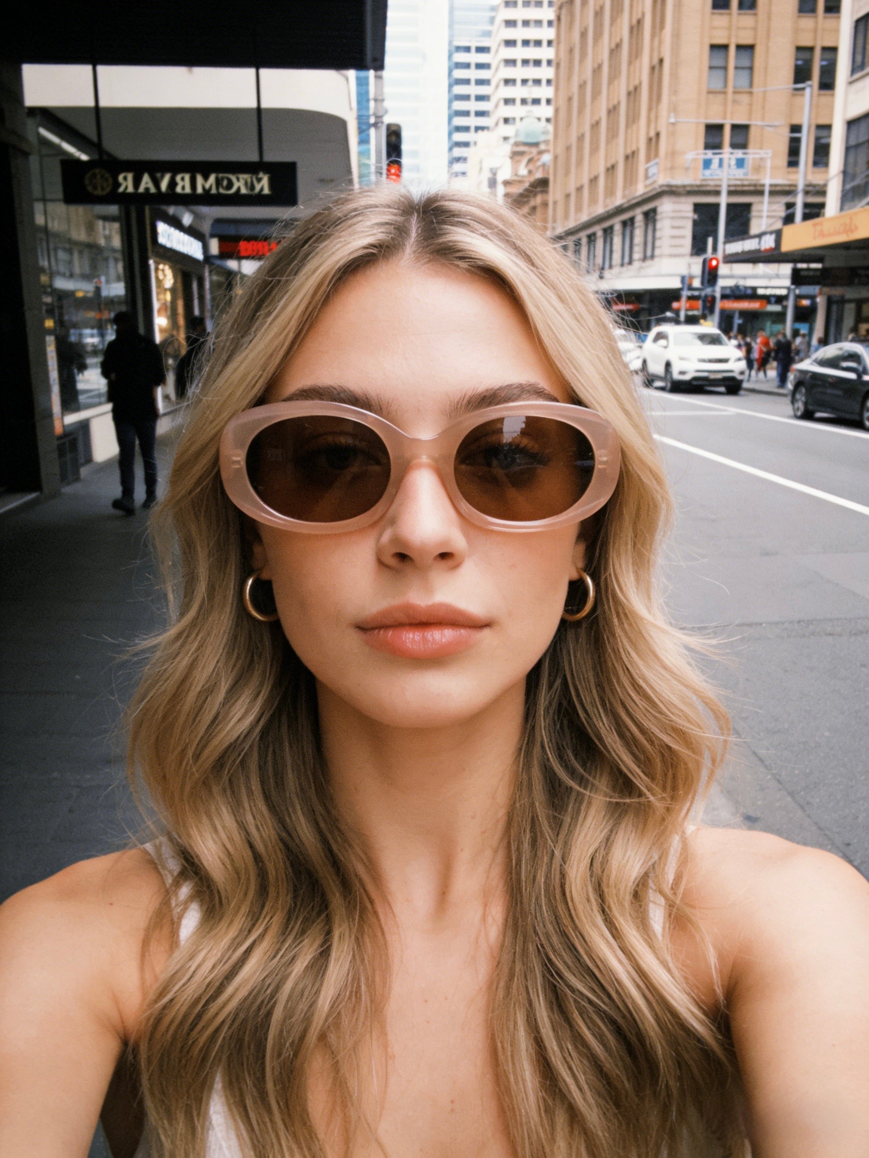 Nude blush oval sunglasses with thick frames and brown polarized lenses, UV protective minimalist eyewear in "Clean Girl" aesthetic. Translucent dusty pink cat-eye sunglasses with gradient polarized lenses and UV protection, retro chic eyewear for women.