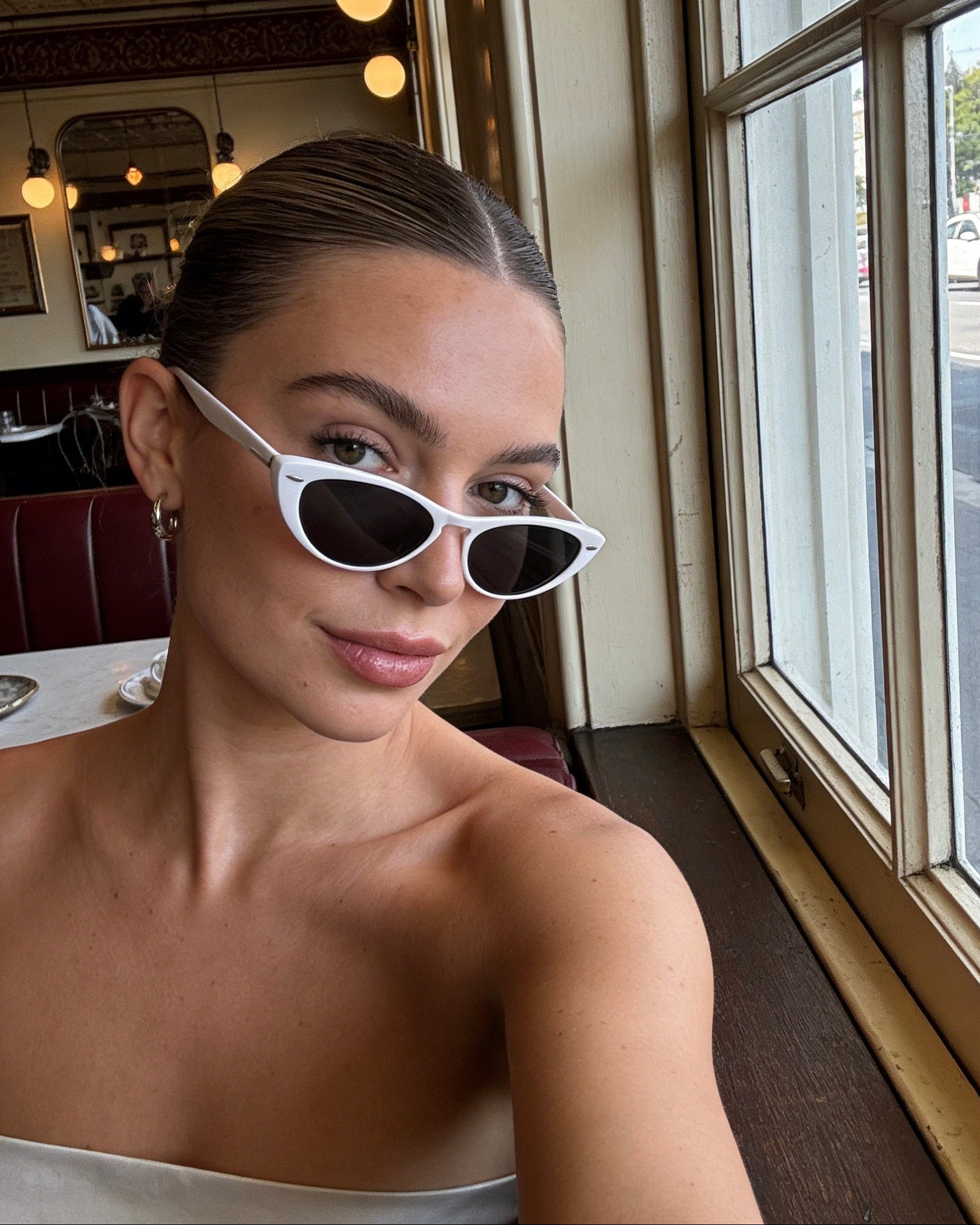 Modern white frame cat-eye sunglasses featuring grey polarized lenses and 100% UV protection, vintage aesthetic fashion sunglasses.