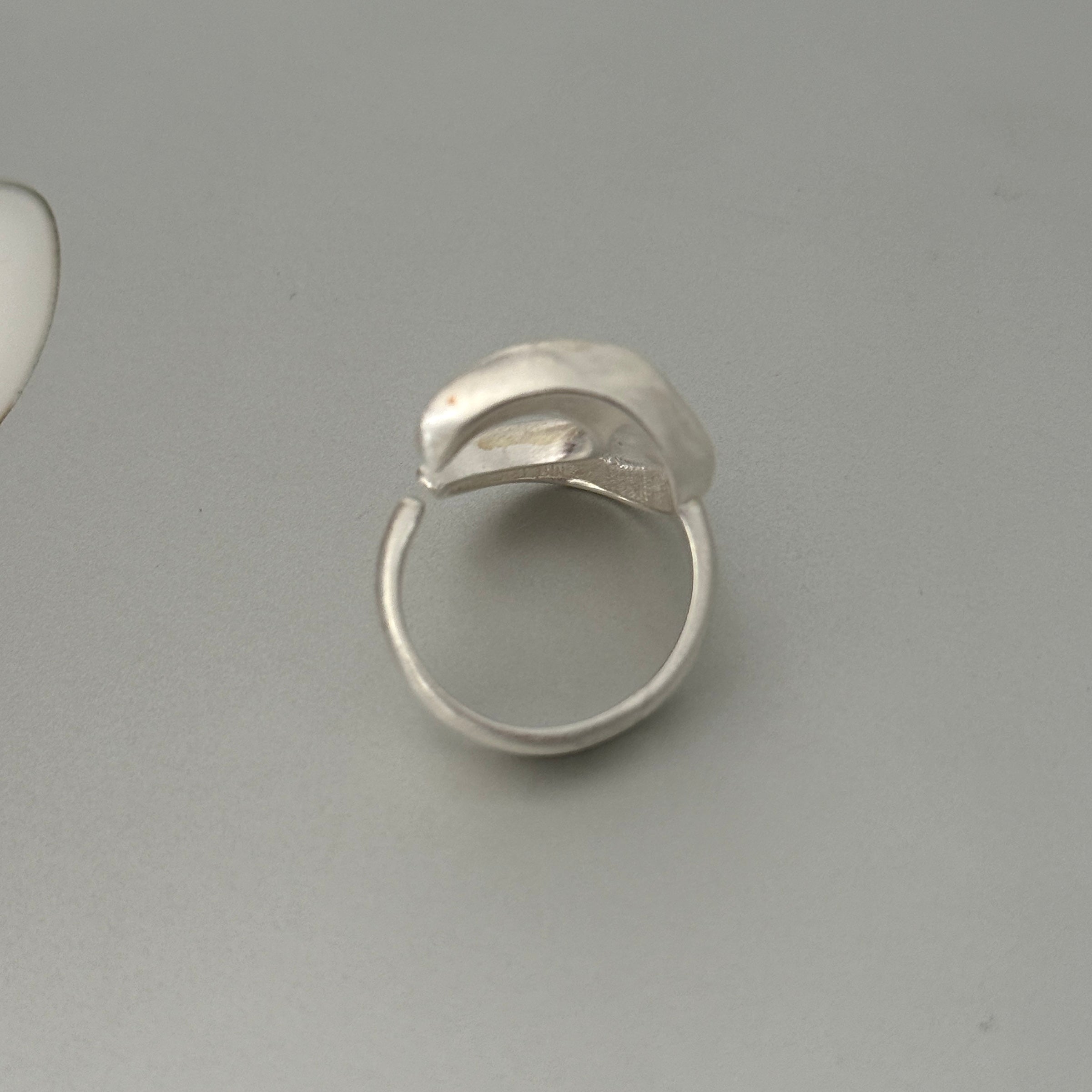 A chunky sterling silver ring featuring a bold, full moon motif with a matte finish. This substantial unisex jewelry piece has an organic and modern sculptural form.