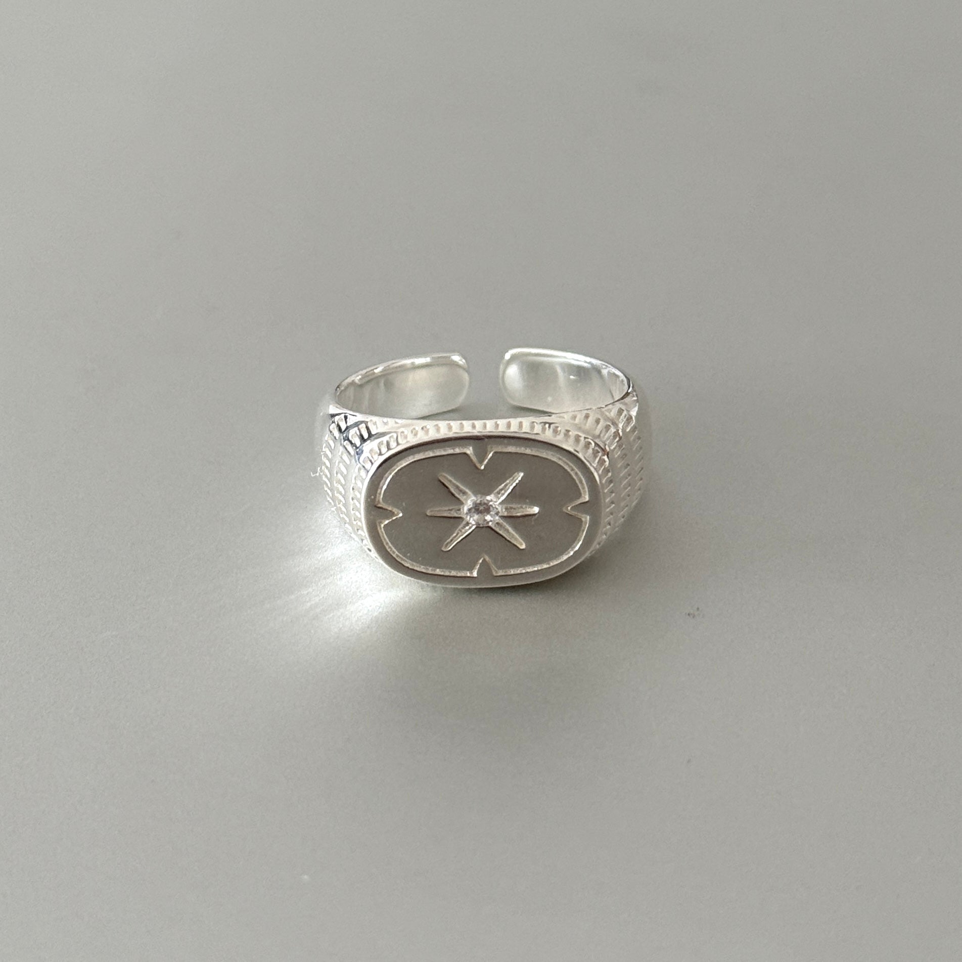Sterling silver unisex ring with a chunky  star design, a bold and architectural piece of statement jewelry.