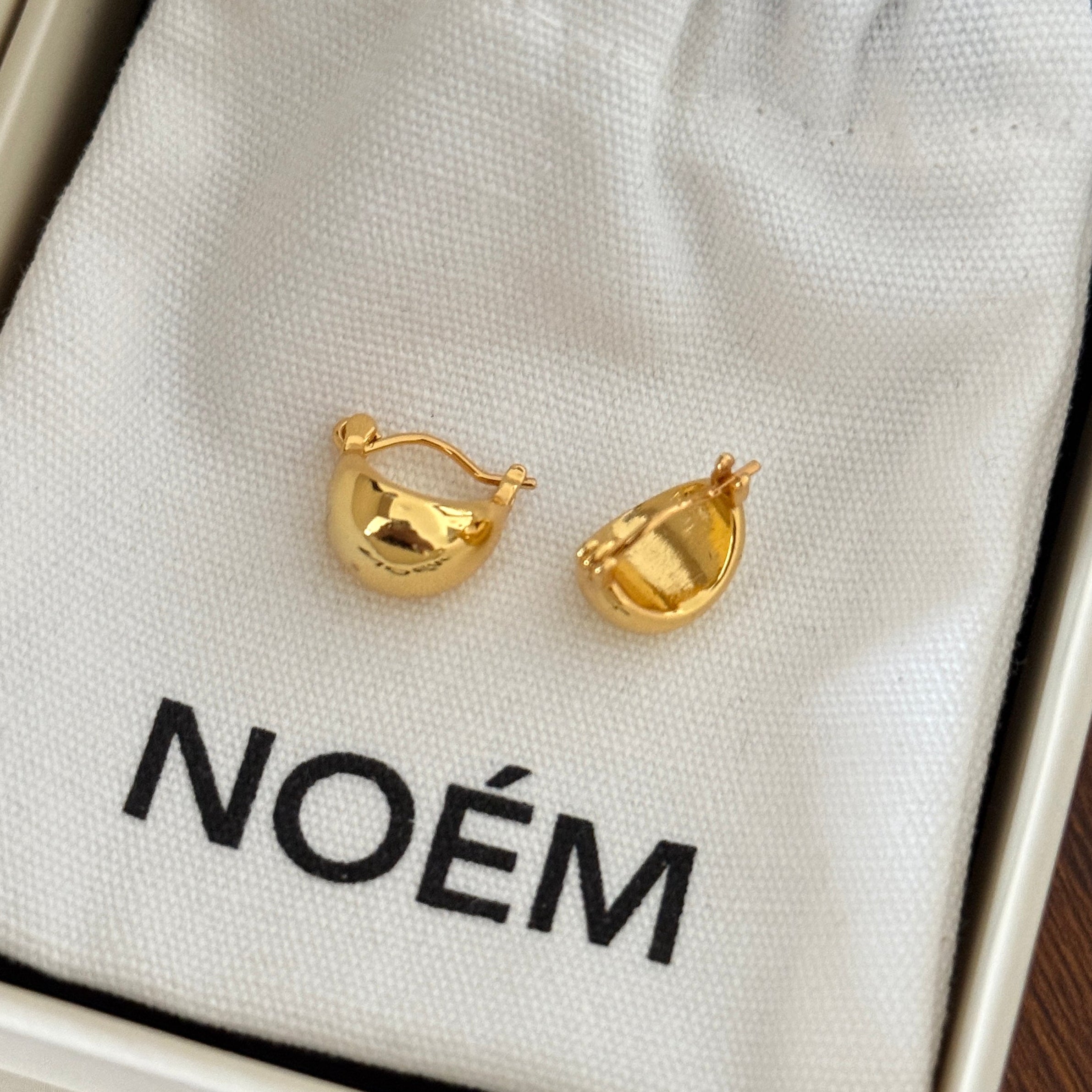 Pair of minimalist 18K gold plated chubby hoop earrings with a high-polished waterdrop silhouette
