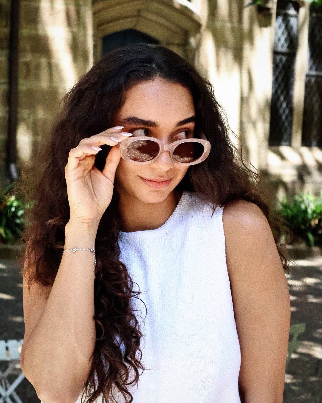 Nude blush oval sunglasses with thick frames and brown polarized lenses, UV protective minimalist eyewear in "Clean Girl" aesthetic. Translucent dusty pink cat-eye sunglasses with gradient polarized lenses and UV protection, retro chic eyewear for women.