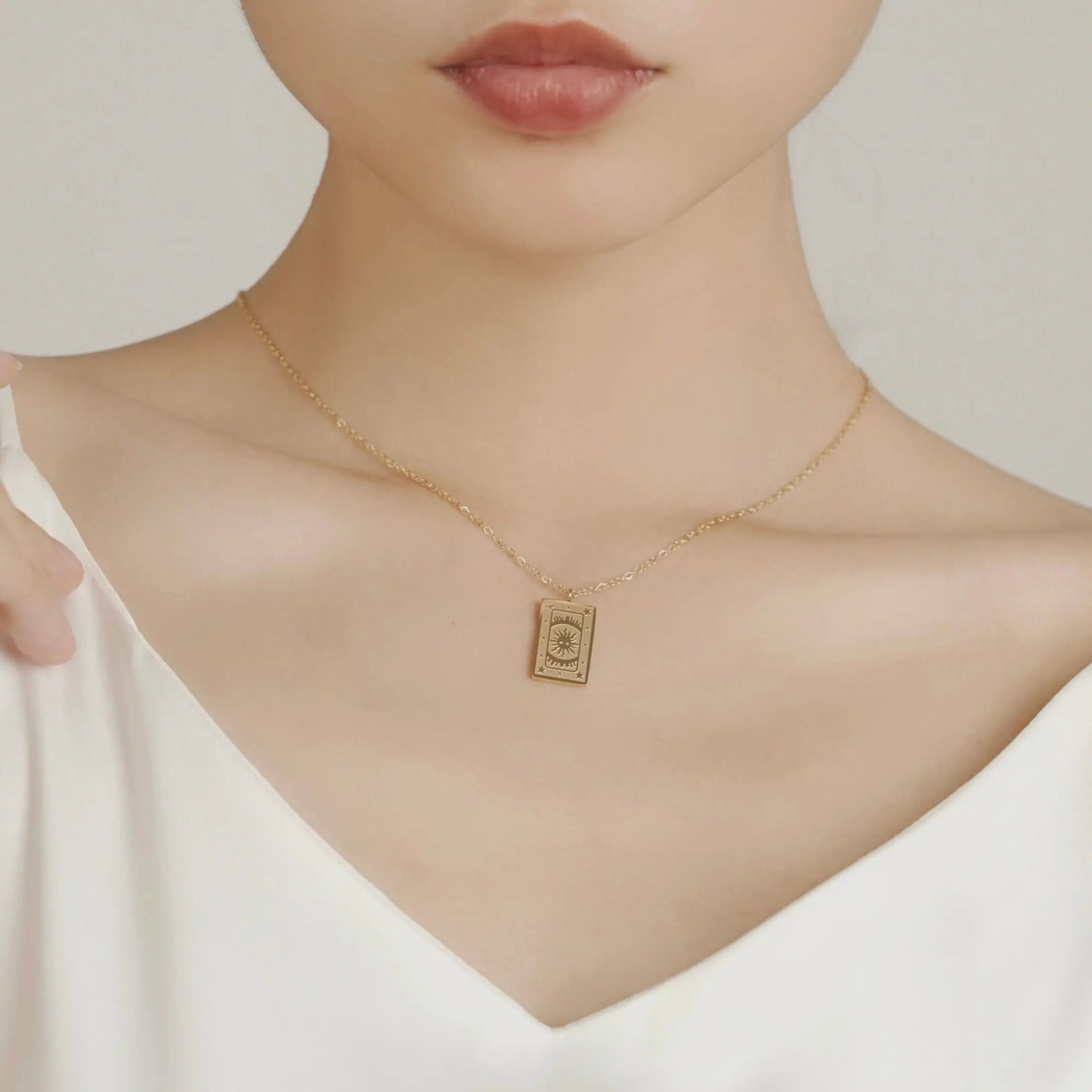 18K gold plated stainless steel tarot card necklace featuring "The Sun" pendant with sunburst and star engravings, dainty gold chain jewelry