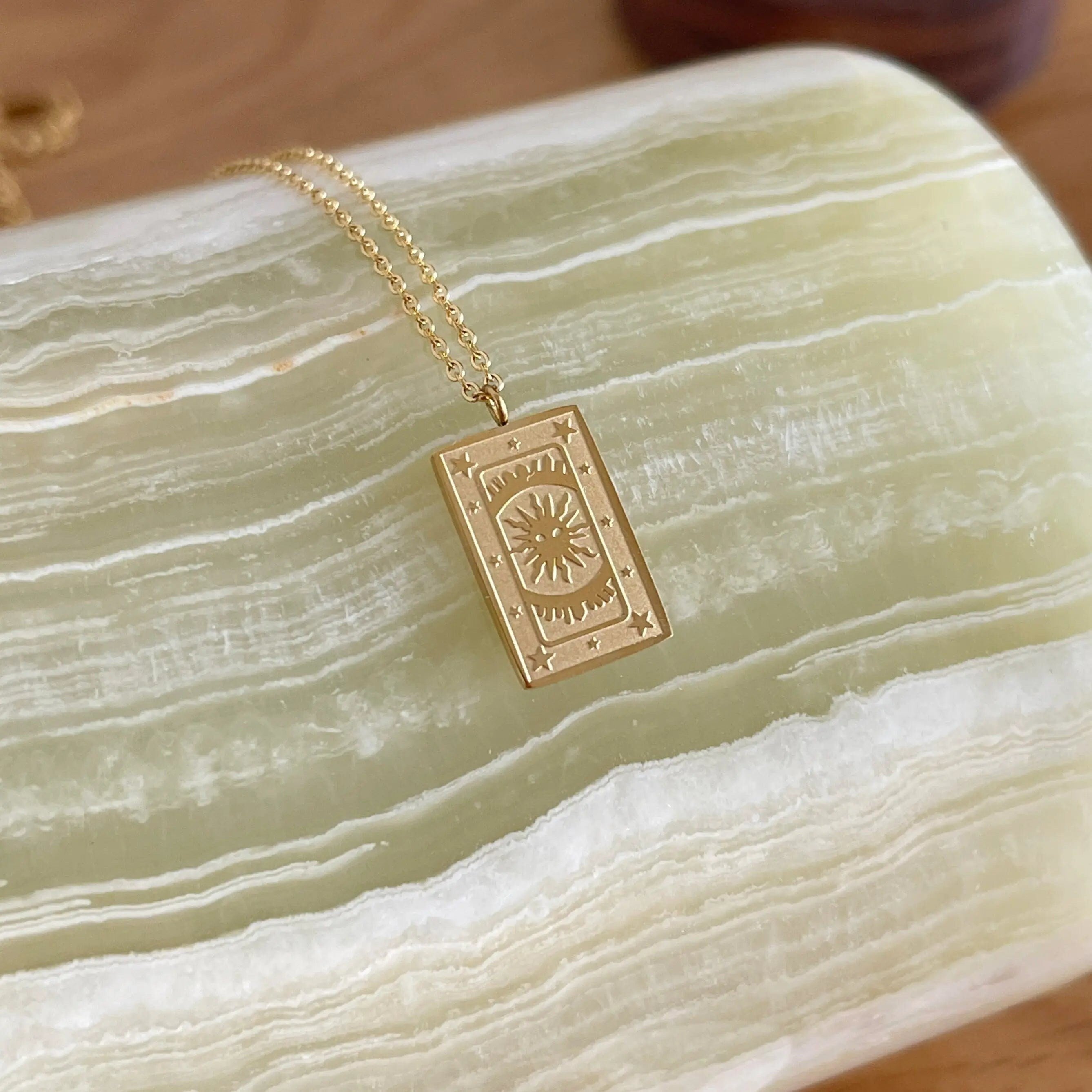 18K gold plated stainless steel tarot card necklace featuring "The Sun" pendant with sunburst and star engravings, dainty gold chain jewelry