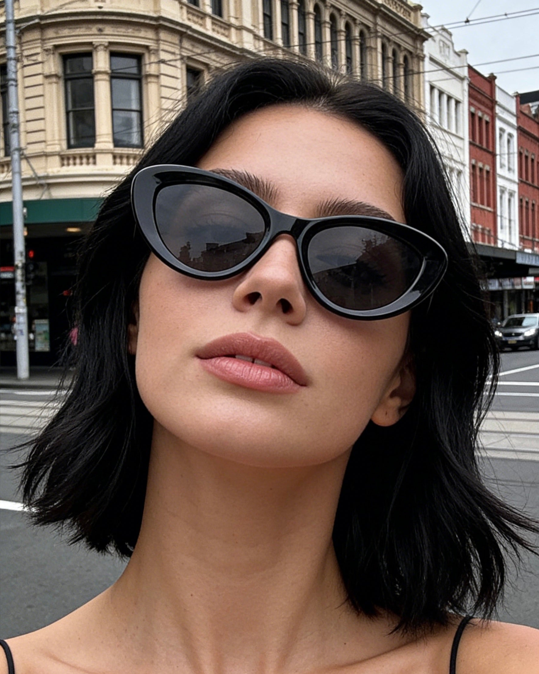 Classic black bold frame cat-eye sunglasses with polarized lenses and UV protection, aesthetic minimalist eyewear.