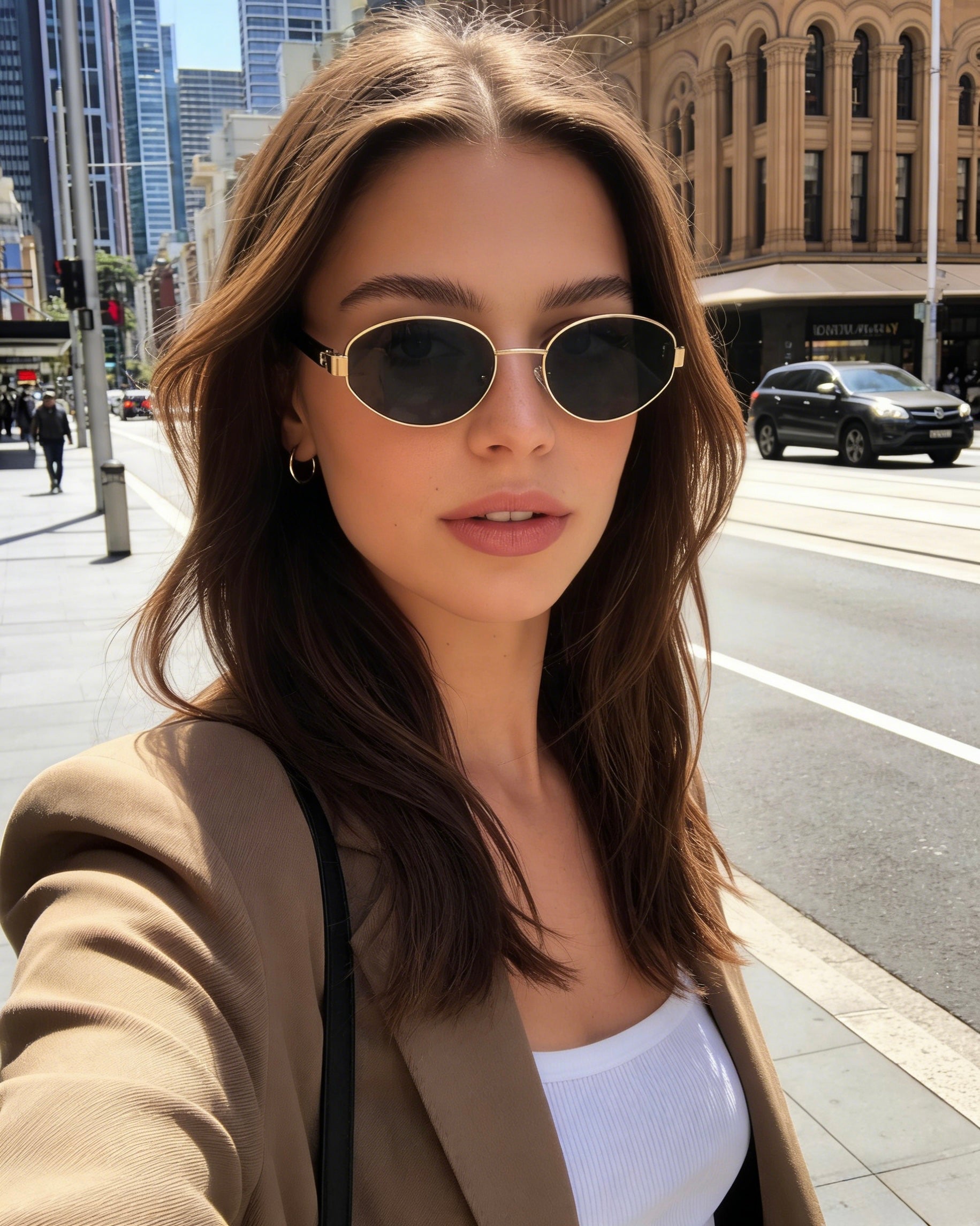 Classic oval polarized sunglasses with gold metal frame and black lenses, eaturing 100% UV protection. Polarized black lens sunglasses with UV protection and stylish gold oval frames for sun safety.