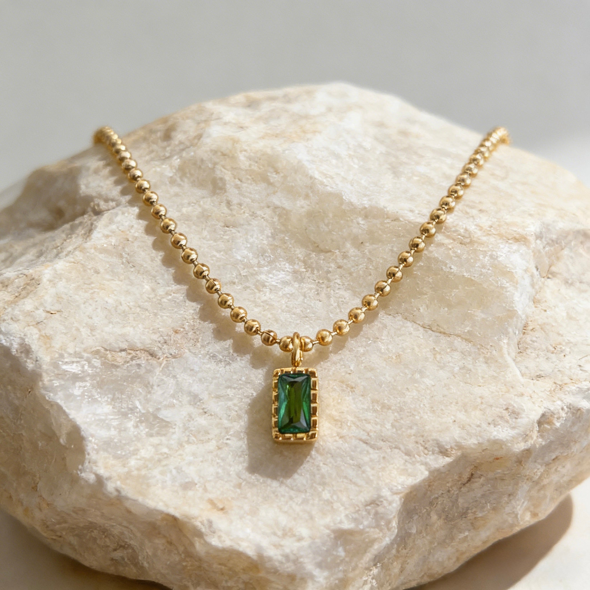 Gold plated beaded chain necklace with emerald cut green pendant, dainty minimalist jewelry. Trendy gold plated ball chain necklace with emerald green rectangular pendant, delicate everyday wear.