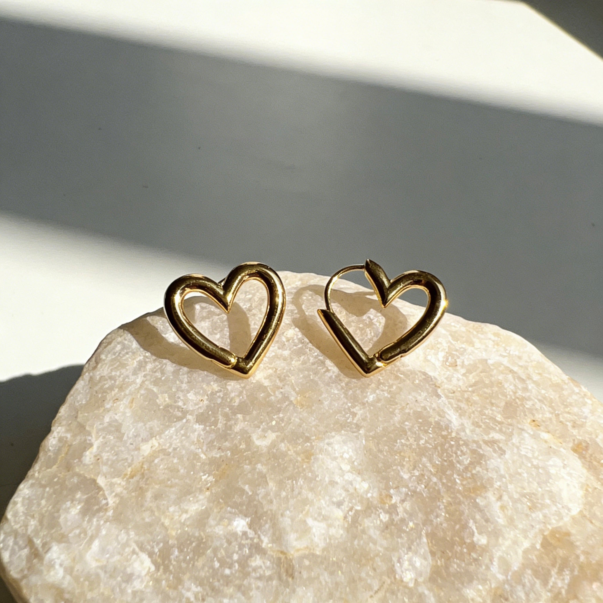 Pair of minimalist 18K gold plated heart hoop earrings featuring unique V-shape architectural lines and S925 sterling silver posts for sensitive ears