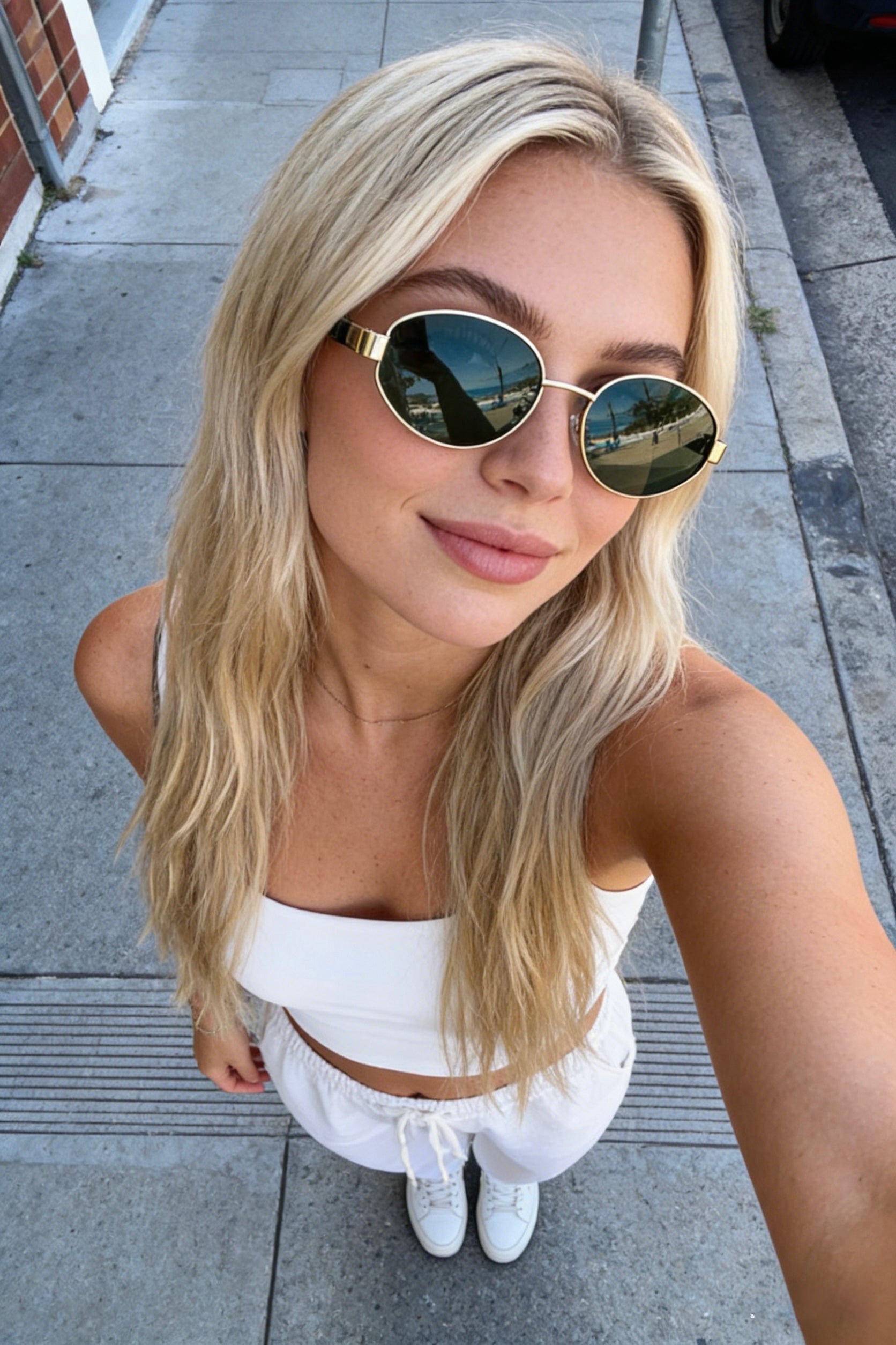 Classic oval polarized sunglasses with gold metal frame and black lenses, featuring 100% UV protection. Polarized black lens sunglasses with UV protection and stylish gold oval frames for sun safety.