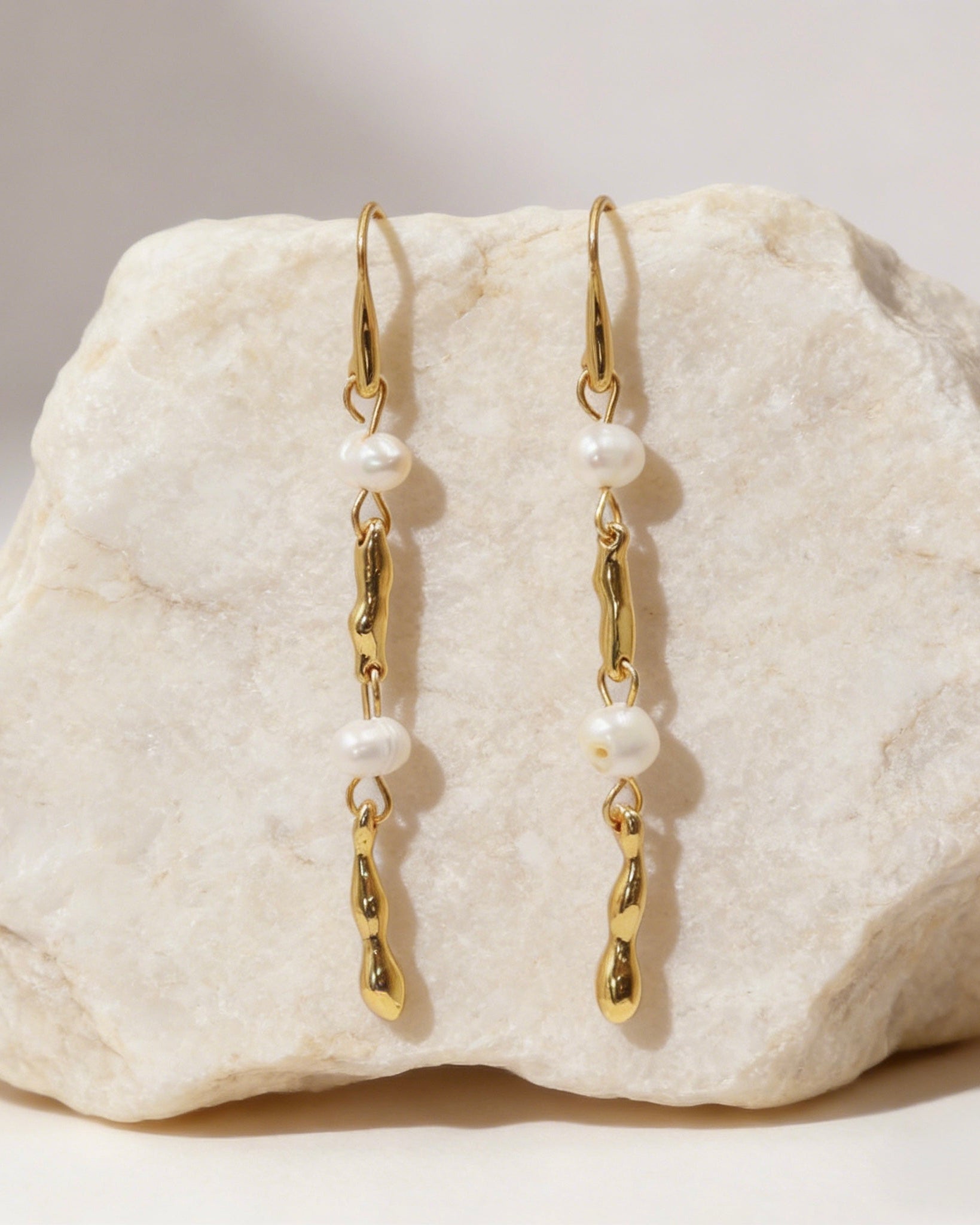 Elegant long 18K gold plated drop earrings featuring fluid melted metal bars and two lustrous white freshwater pearls with S925 sterling silver post.