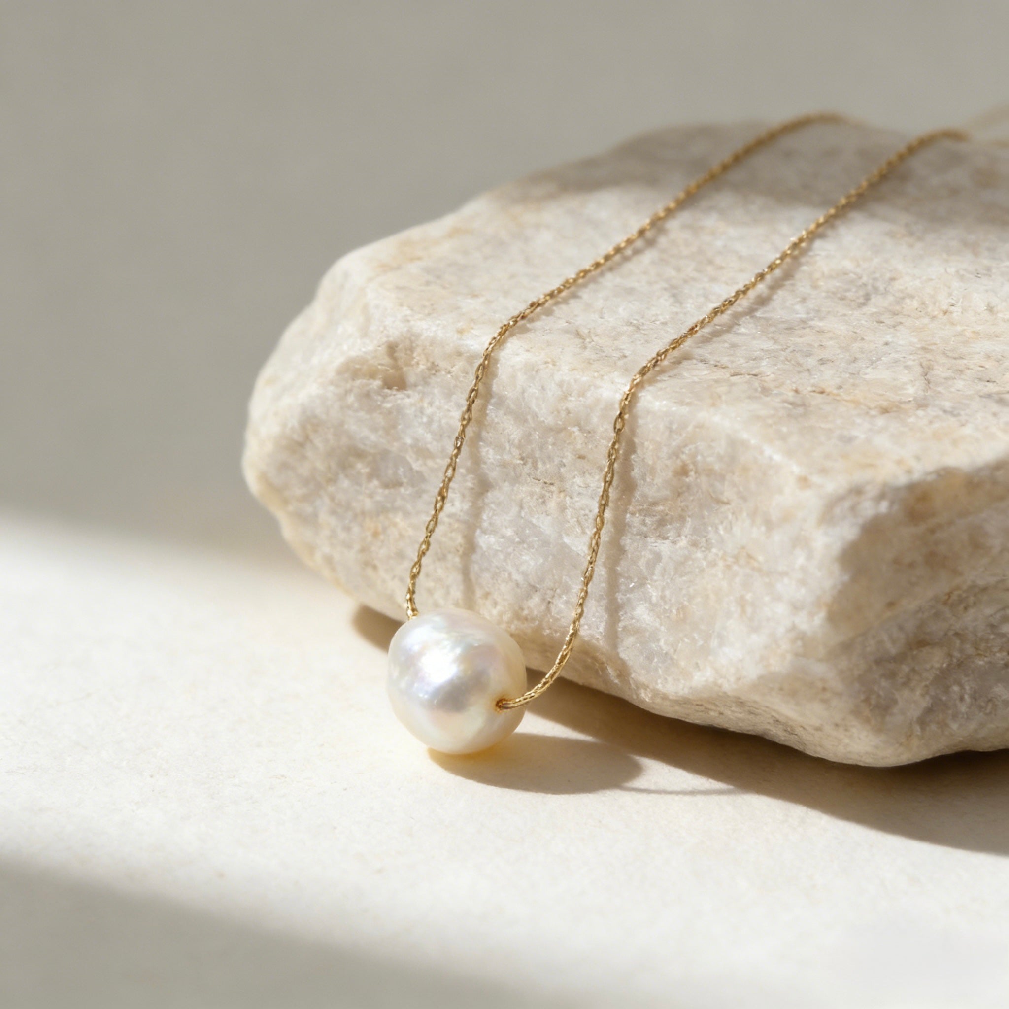 Minimalist 18K gold plated floating necklace with a natural white freshwater baroque pearl on a dainty cable chain