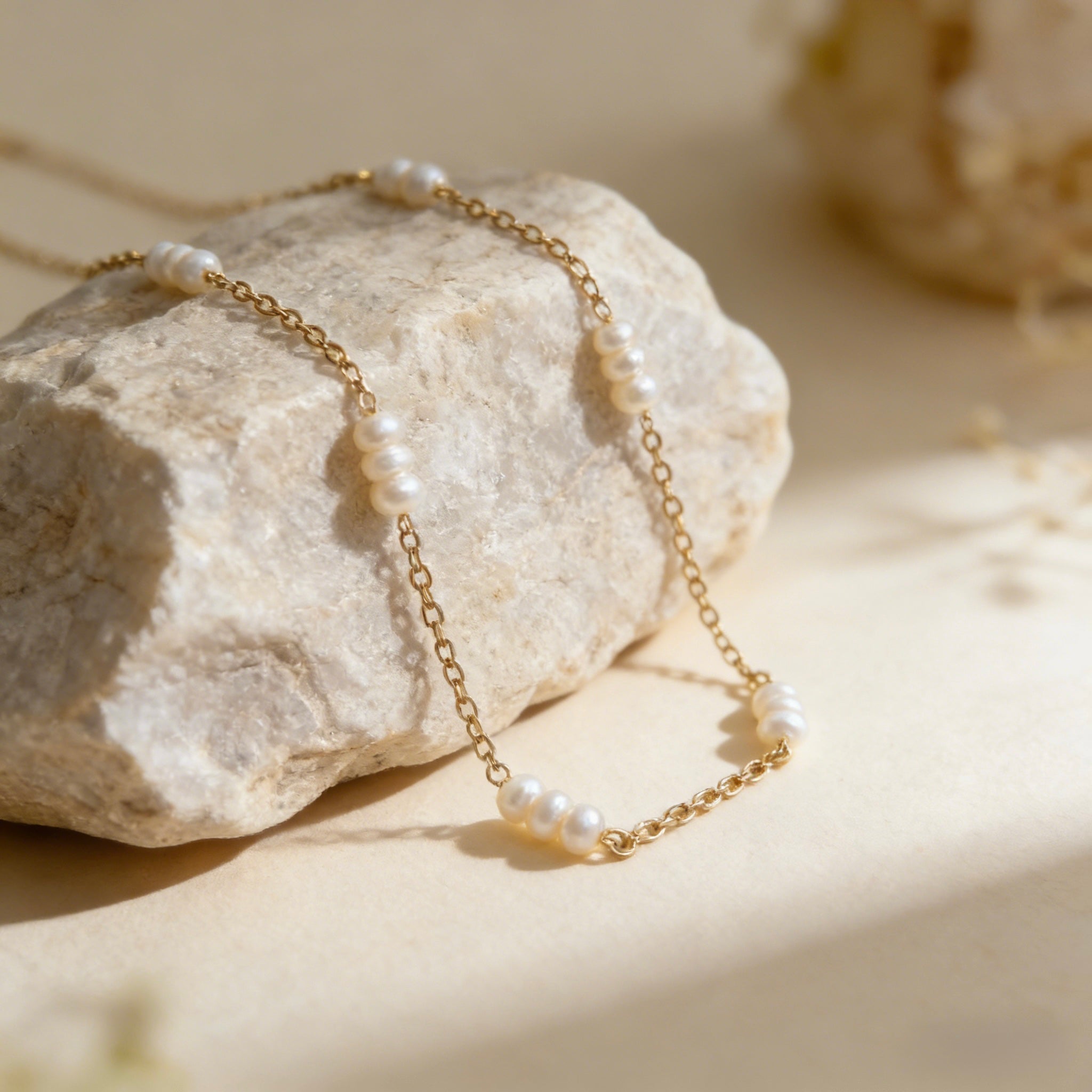 Dainty 18K gold plated station necklace featuring small white freshwater rice pearls spaced evenly on a fine gold chain