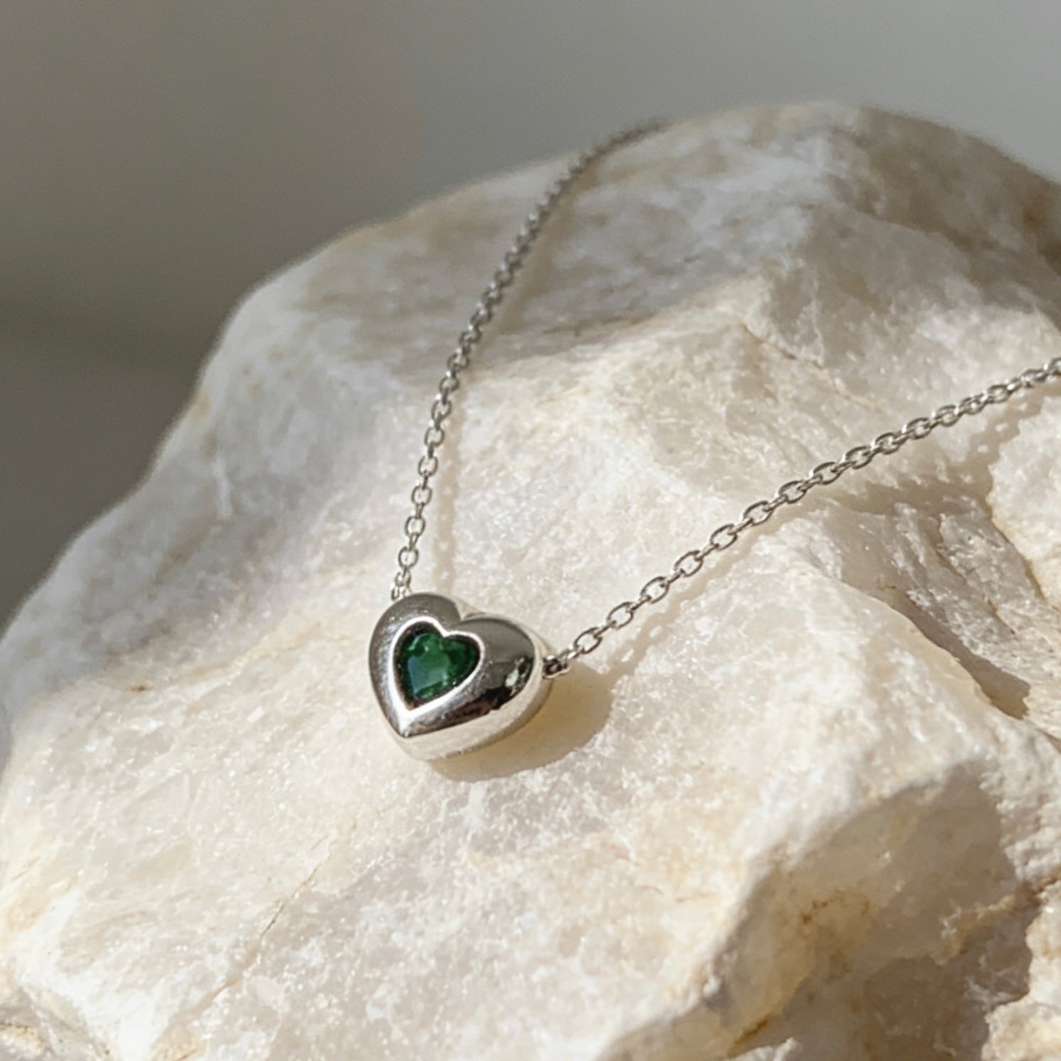 18K gold plated over sterling silver heart-in-heart green zircon necklace featuring a central black heart-shaped zircon on a dainty gold chain