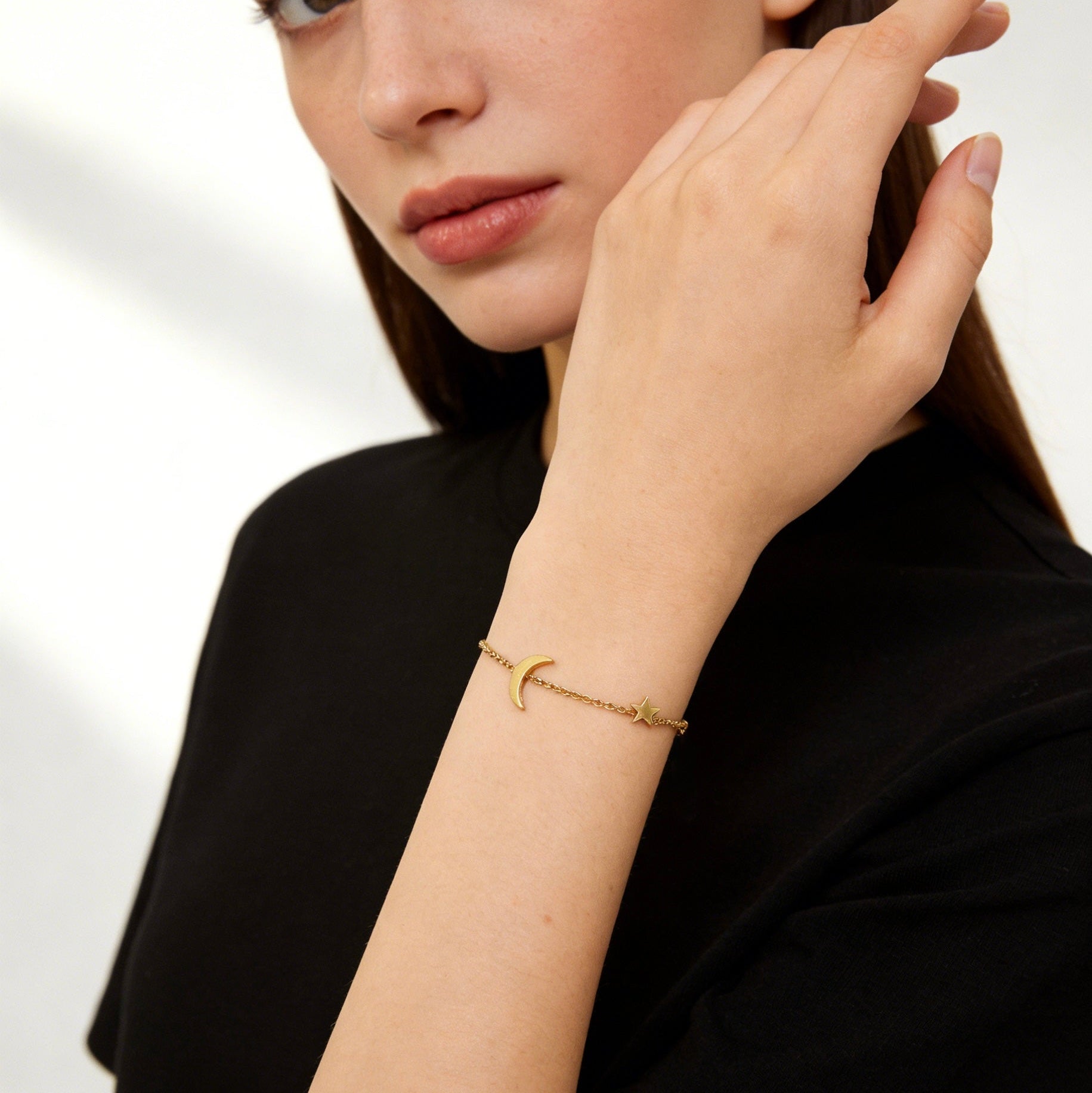 18K gold plated stainless steel celestial bracelet featuring a small crescent moon and star charm, dainty gold cable chain jewelry