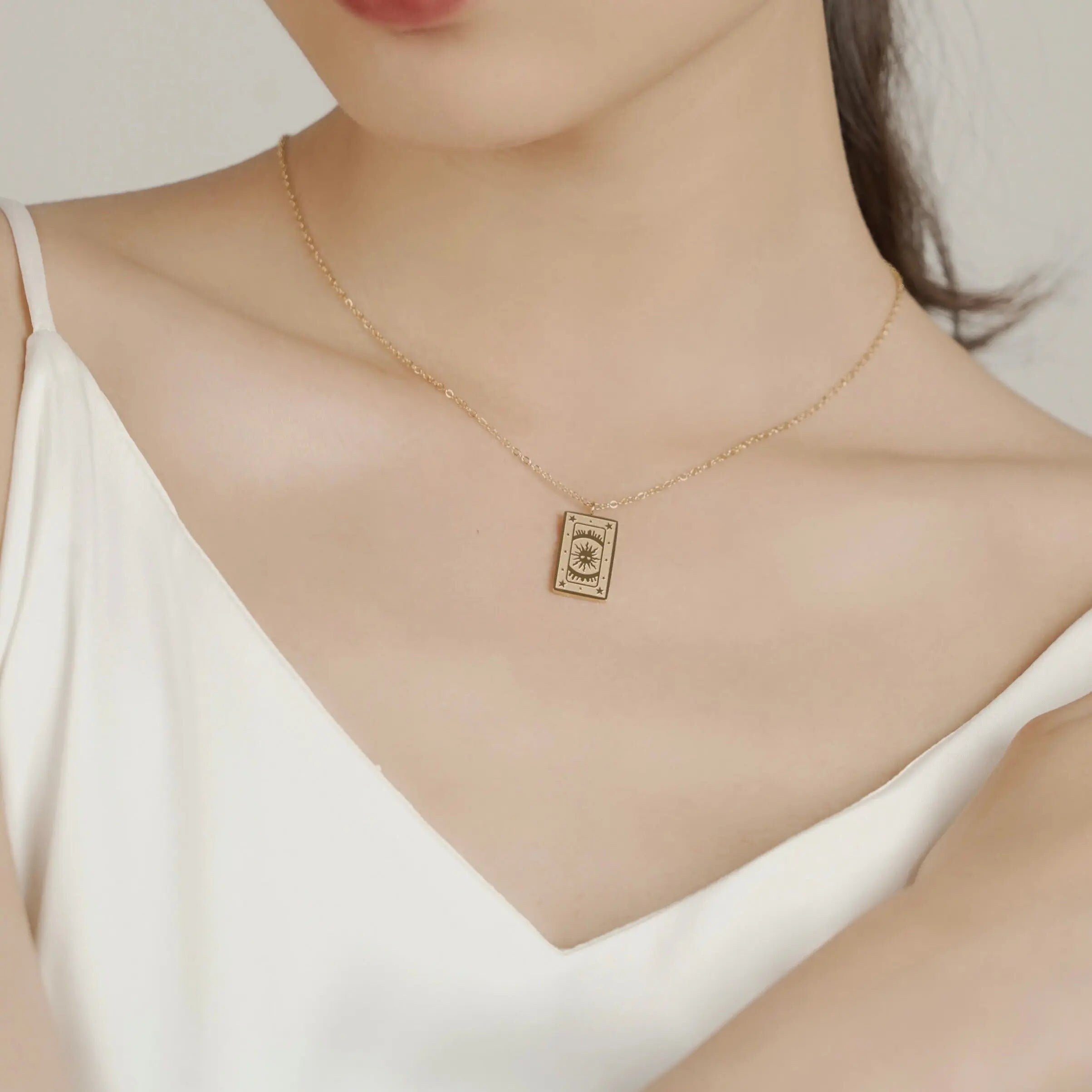 18K gold plated stainless steel tarot card necklace featuring "The Sun" pendant with sunburst and star engravings, dainty gold chain jewelry
