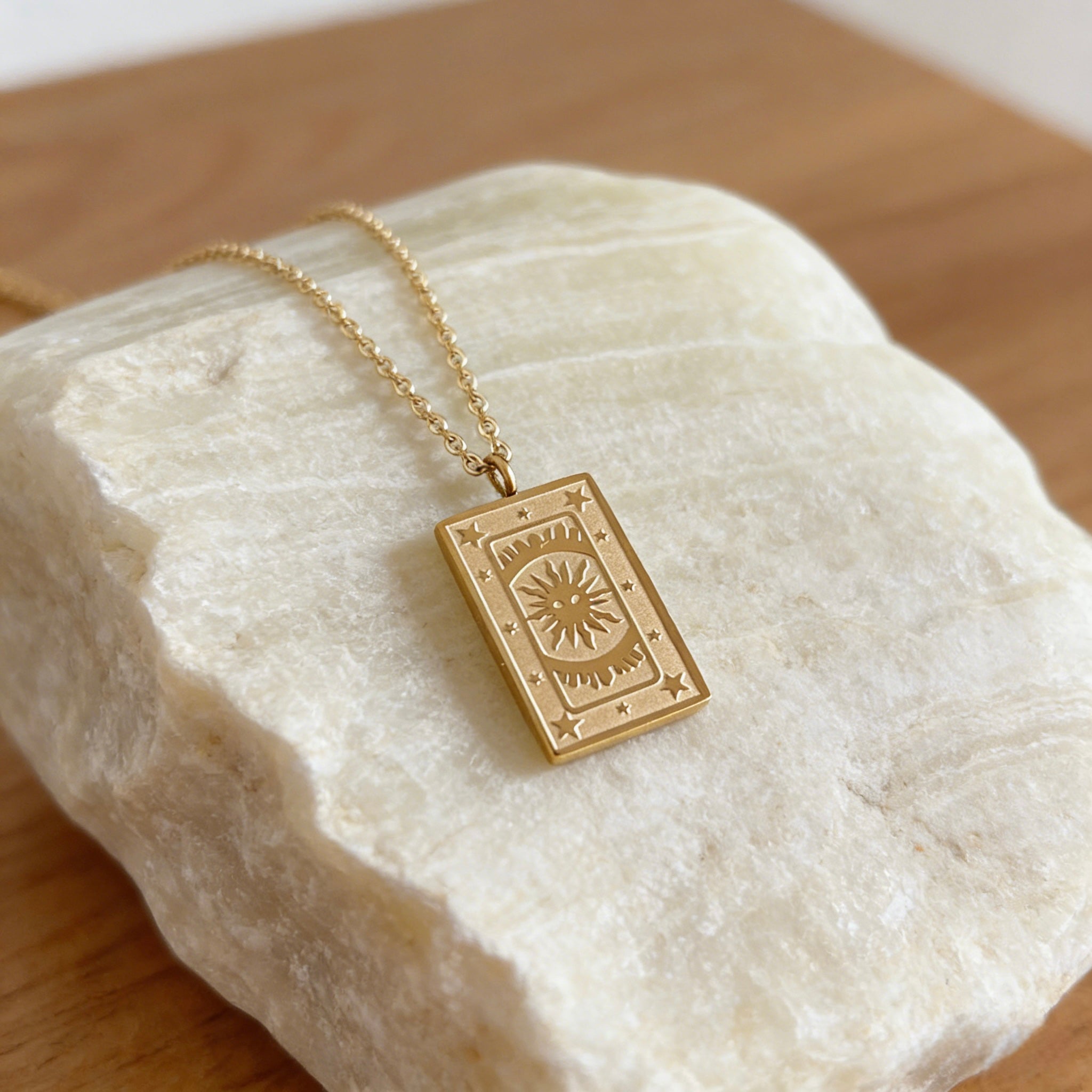 18K gold plated stainless steel tarot card necklace featuring "The Sun" pendant with sunburst and star engravings, dainty gold chain jewelry