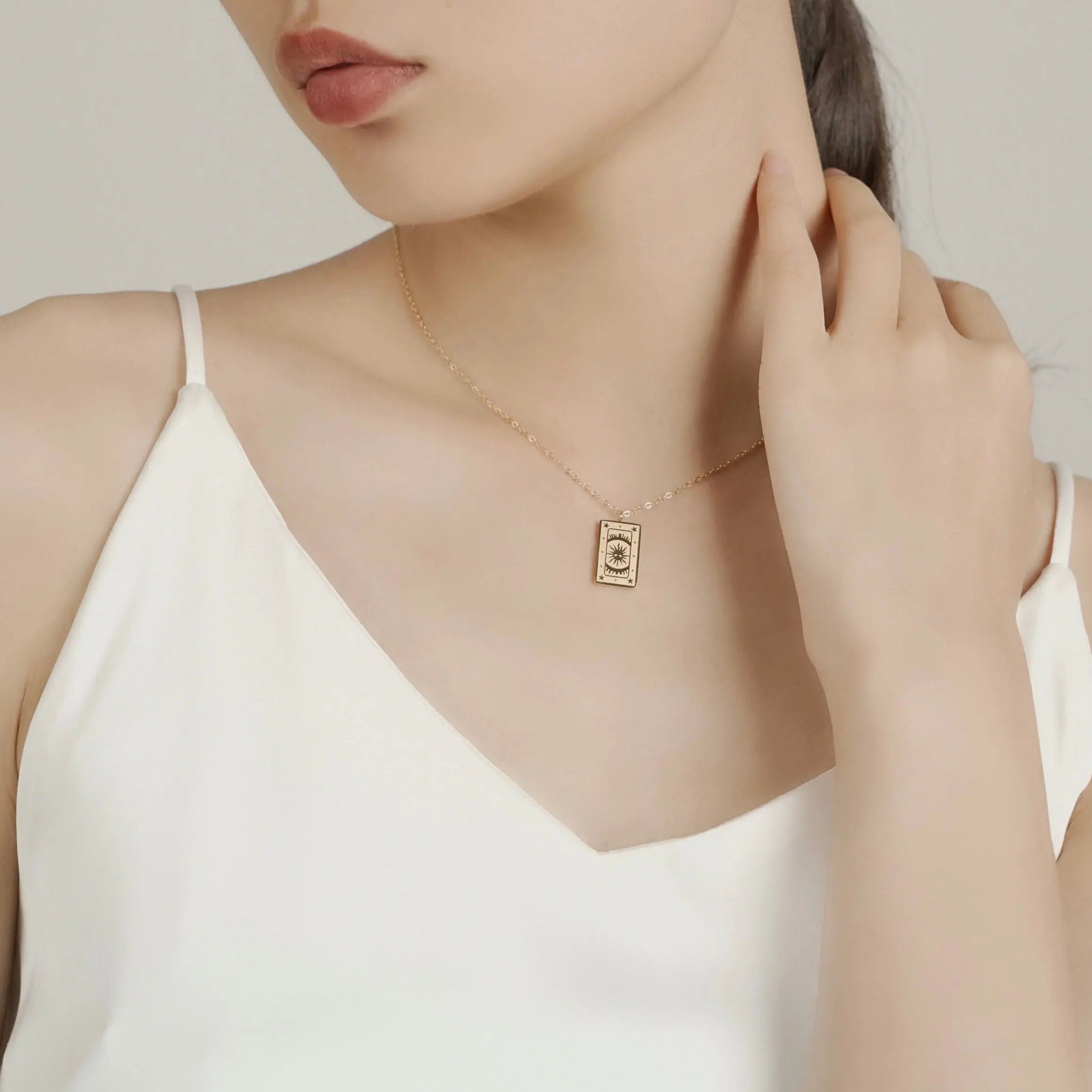 18K gold plated stainless steel tarot card necklace featuring "The Sun" pendant with sunburst and star engravings, dainty gold chain jewelry